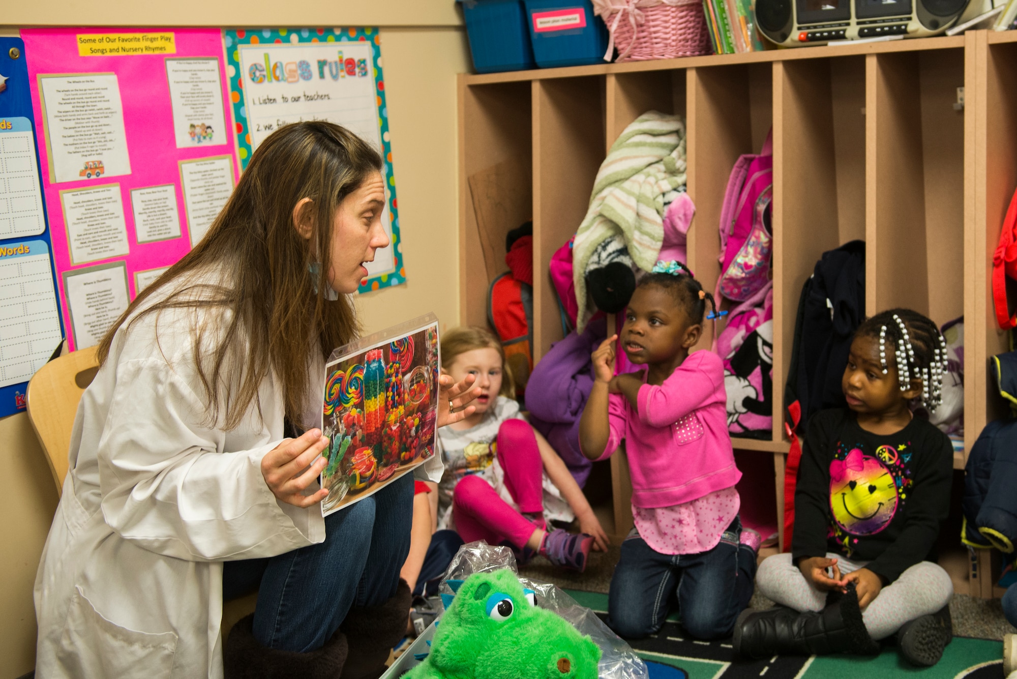 Dawn Greene, 23d Aerospace Medicine Squadron dental assistant, speaks with Child Development Center students about teeth care Feb. 10, 2015, at Moody Air Force Base, Ga. Greene spoke about the dangers of sugar consumption and risk of cavities from not brushing their teeth. (U.S. Air Force photo by Airman 1st Class Dillian Bamman/Released)