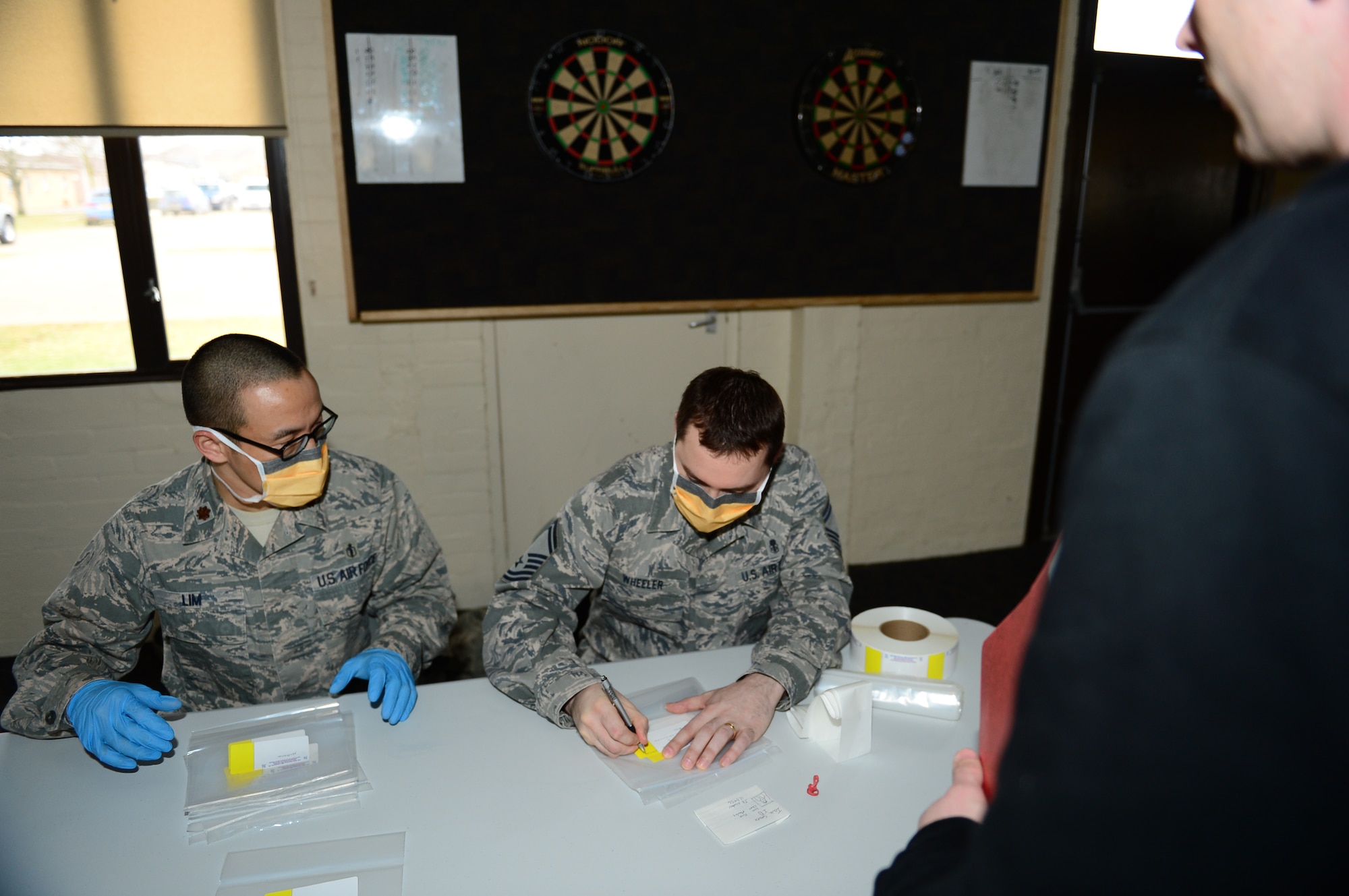 Maj. Daniel Lim, 48th Medical Group pharmacy flight commander, and Senior Master Sgt. Charles Wheeler, 48th MDG pharmacy medical group flight chief, dispense medicine to patients that were in quarantine as a part of a disease containment plan exercise at Royal Air Force Lakenheath, England, Feb. 10, 2015. The DCP exercise evaluated the 48th Fighter Wing’s ability to respond to and contain a contagious disease outbreak amongst the base population to ensure the 48th FW is Forward, Ready, Now. (U.S. Air Force photo by Airman 1st Class Erin R. Babis)