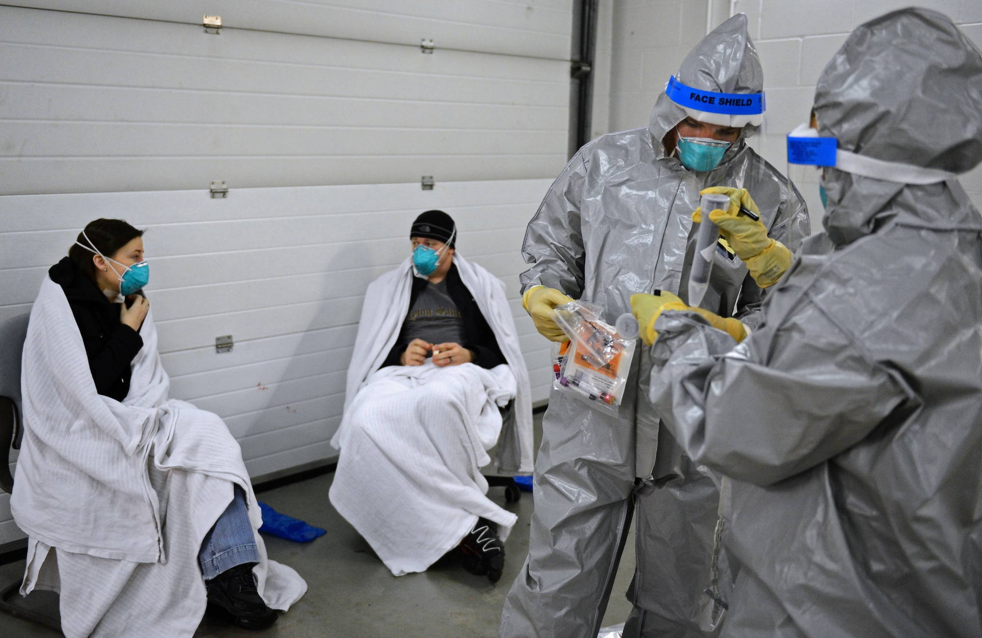 Airman 1st Class Steven Taylor, 48th Medical Group emergency services technician, and Capt. Erica Middleton, 48th MDG emergency room services nurse, collect samples taken from patients for analysis as a part of a disease containment plan exercise at Royal Air Force Lakenheath, England, Feb. 10, 2015. The DCP exercise tested 48th Fighter Wing personnel and their ability to respond to and contain a contagious disease outbreak to ensure the 48th FW is Forward, Ready, Now. (U.S. Air Force photo by Airman 1st Class Erin R. Babis)
