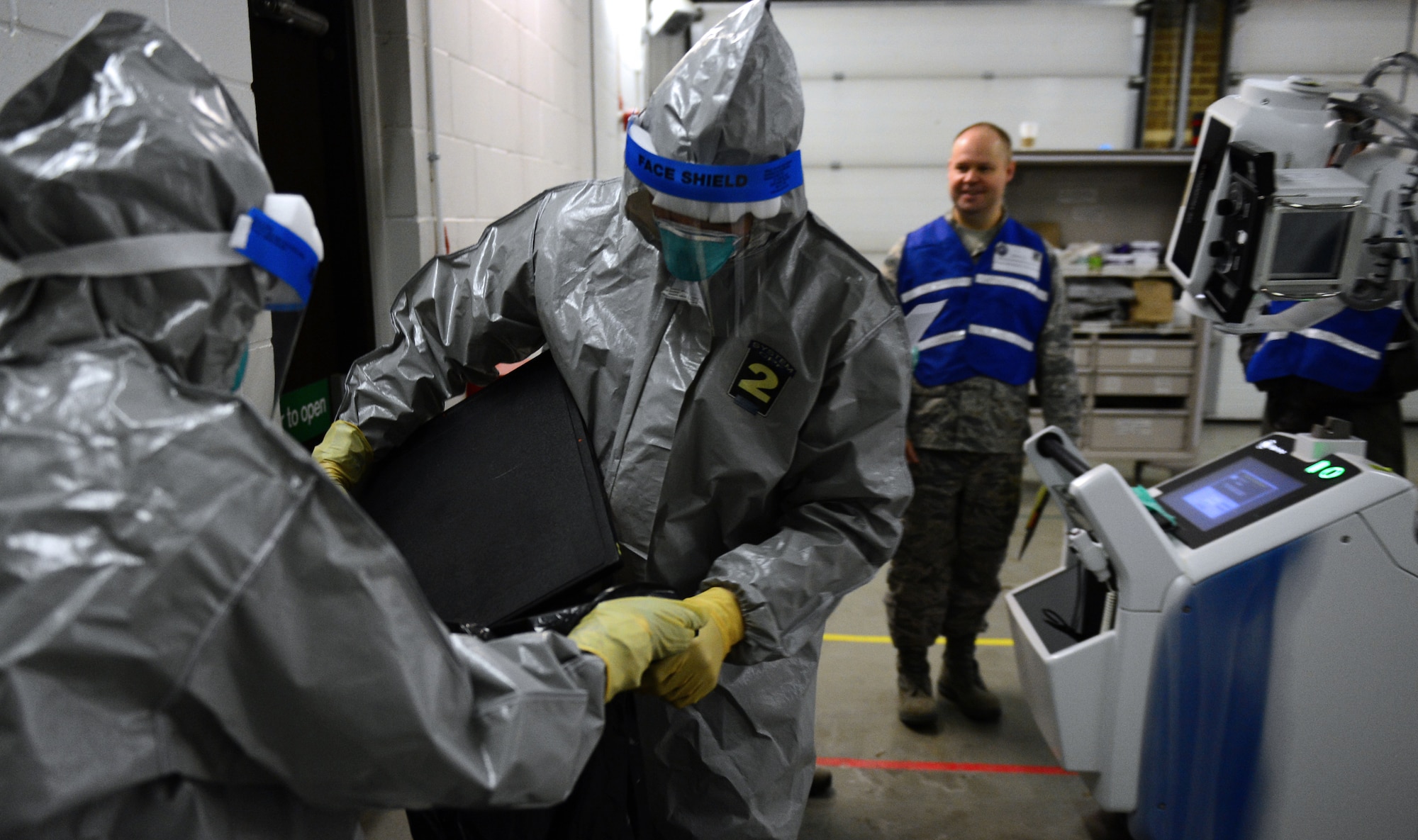 Airman 1st Class Steven Taylor, 48th Medical Group emergency services technician, and Capt. Erica Middleton, 48th MDG emergency room services nurse, package scans of patients’ lungs for analysis during a disease containment plan exercise at Royal Air Force Lakenheath, England, Feb. 10, 2015. This was the first time RAF Lakenheath executed a practical DCP exercise, which evaluates the 48th Fighter Wing’s ability to respond to and contain a contagious disease outbreak. (U.S. Air Force photo by Airman 1st Class Erin R. Babis)
