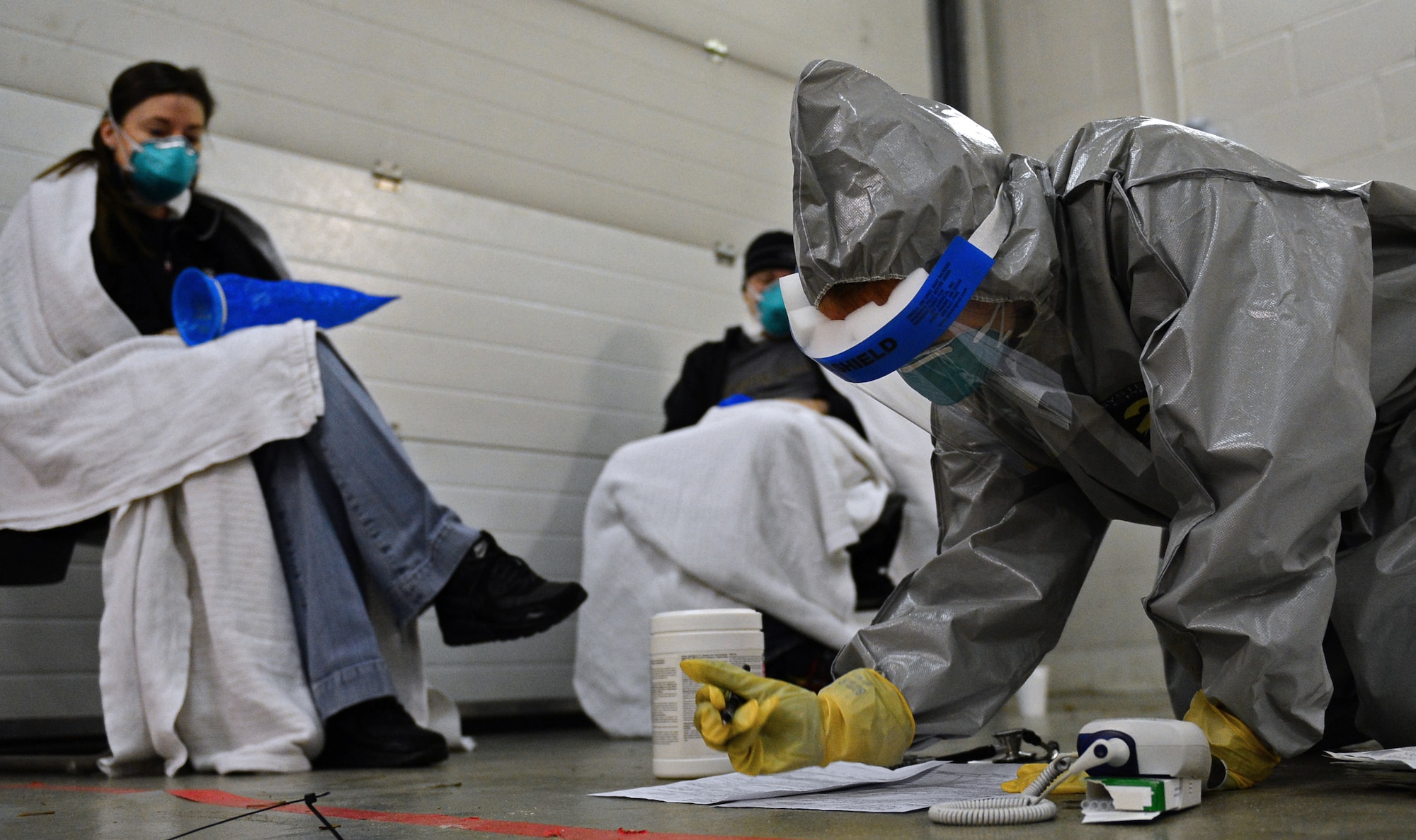 Capt. Erica Middleton, 48th Medical Group emergency room services nurse, records patient information during a disease containment plan exercise at Royal Air Force Lakenheath, England, Feb. 10, 2015. The DCP exercise evaluated the 48th Fighter Wing’s ability to respond to and contain a contagious disease outbreak amongst the base population to ensure the 48th FW is Forward, Ready, Now. (U.S. Air Force photo by Airman 1st Class Erin R. Babis)