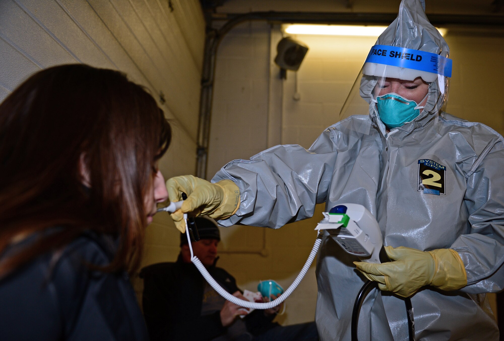 Maj. Terri Jennings, 48th Medical Group emergency services nurse, examines Staff Sgt. Amanda Beckwith, 48th MDG NCO in charge of ambulance services, during a disease containment plan exercise at Royal Air Force Lakenheath, England, Feb. 10, 2015. The purpose of the exercise was to evaluate the 48th Fighter Wing’s ability to respond to and contain a contagious disease outbreak amongst the base population, ensuring the 48th FW is Forward, Ready, Now. (U.S. Air Force photo by Airman 1st Class Erin R. Babis)