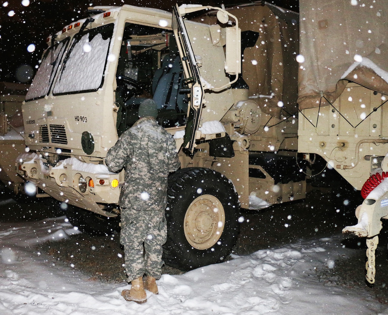 A Virginia National Guard soldier assigned to the Fredericksburg-based 116th Brigade Special Troops Battalion, 116th Infantry Brigade Combat Team, prepares a Humvee for possible winter storm operations duty in Fredericksburg, Va., Feb. 16, 2015. Virginia National Guard photo by Capt. Andrew J. Czaplicki