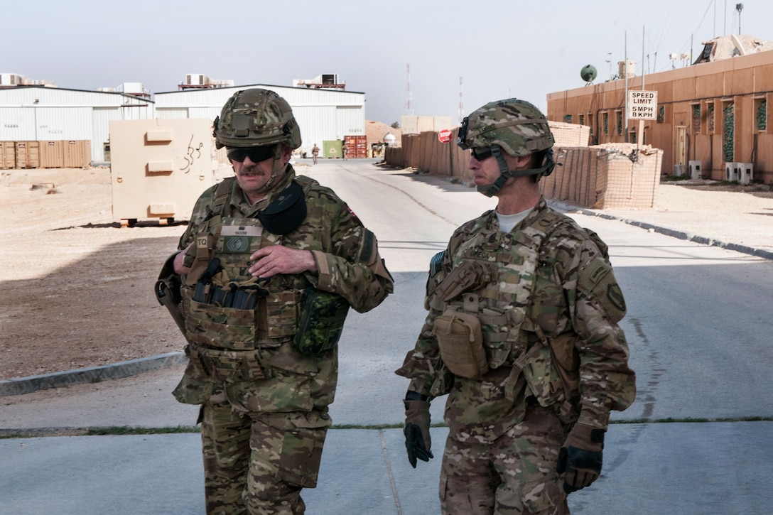 U.S. Army Command Sgt. Maj. Christopher K. Greca, right, walks with a ...