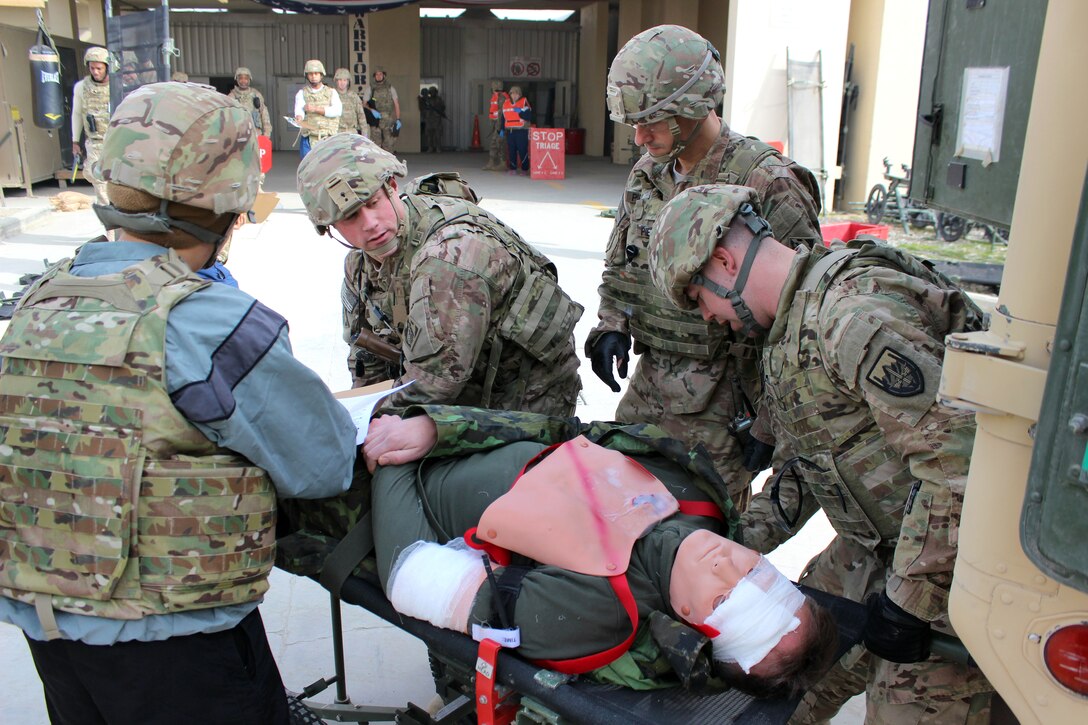U.S. soldiers start the triage process on a simulated casualty during a combined joint training exercise on Bagram Airfield, Afghanistan, Feb. 6, 2015. The soldiers are assigned to the Craig Joint Theater Hospital.