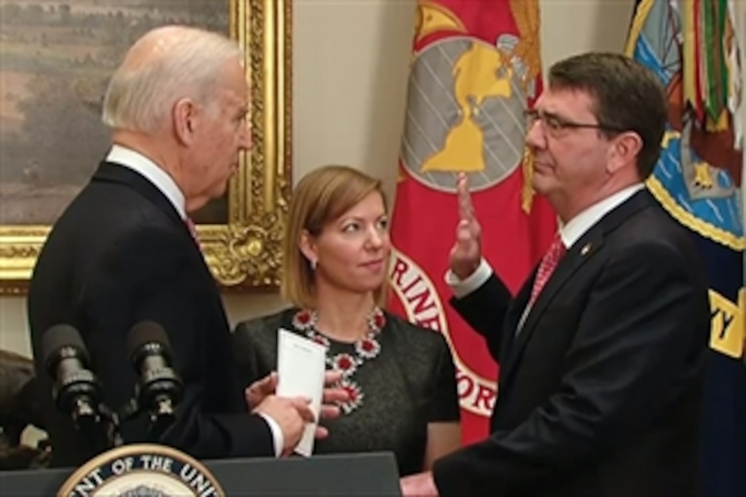 Vice President Joe Biden swears in Ash Carter as the 25th defense secretary as Carter's wife, Stephanie, looks on during a private ceremony at the White House, Feb. 17, 2015.