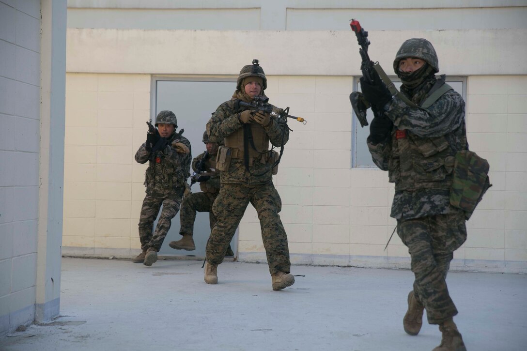 Republic of Korea and U.S. Marines clear a building during Korean Marine Exchange Program 15-17 Feb. 9 at the Cham Sae Mi Close-Quarters Battle Training Facility in Pohang, Republic of Korea. KMEP 15-17 is a regularly-scheduled, bilateral, small-unit training exercise, which enhances the combat readiness and interoperability of ROK and U.S. Marine Corps forces. The ROK Marines are with Company 5, 32nd Battalion, 1st ROK Marine Division. The U.S. Marines are with Company I, 3rd Battalion, 3rd Marine Regiment, currently assigned to 4th Marine Regiment, 3rd Marine Division, III Marine Expeditionary Force under the unit deployment program.