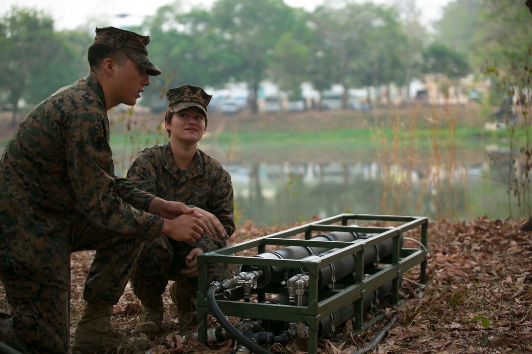 Cpl. Abraham Ostosmendoza, from Staten Island, New York, and Lance Cpl. Jamie Neal, from Houma, Louisiana, purify pond water Feb. 11 during exercise Cobra Gold 2015 at Ban Chan Krem, Thailand. The U.S. Marines utilized the Light Weight Water Purification System, and consistently checked the gauges, temperature, and pressure to ensure it was efficiently supplied to the Royal Thai Marines and the ranges. Ostosmendoza is water support technician with 9th Engineer Support Battalion, 3rd Marine Logistics Group, III Marine Expeditionary Force. Neal is a water support technician with Combat Logistics Battalion 4, 3rd MLG. 