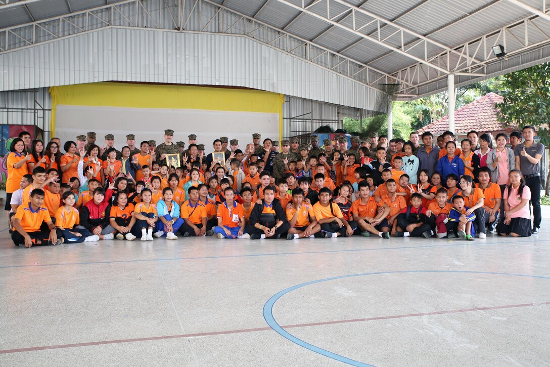 Members of the Royal Thai Air Force, U.S. Marine Corps and U.S. Navy take a group photo with the staff and students from Nakhon Ratchasima Panyonnookun School for children with disabilities, February 12. Marines with 1st Marine Aircraft Wing and members of the Royal Thai Air Force volunteered at the school during Exercise Cobra Gold 2015 to spend time in the community. The volunteers spent the day playing games and teaching the students English. For more information on Exercise Cobra Gold, please visit the official Facebook page at http://www.facebook.com/ExerciseCobraGold.