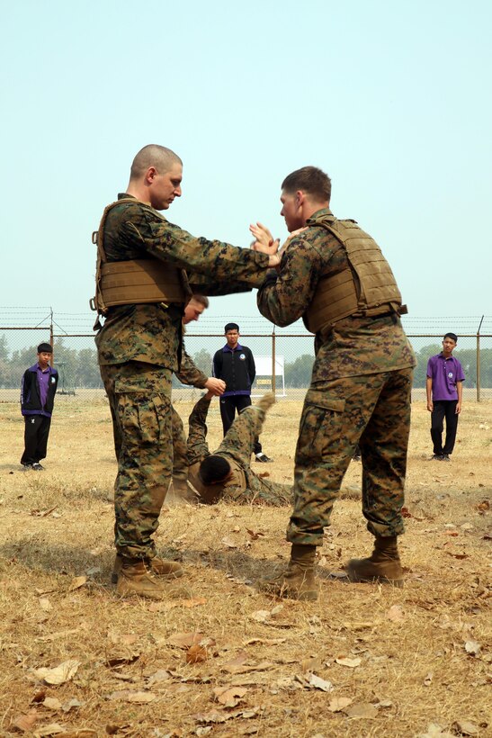 Students from Yothinnukun School watch a demonstration of Marine Corps Martial Arts at during Friendship Day held by Royal Thai Air Force Wing 1 and U.S. Marines at Royal Thai Air Force Base Korat during Exercise Cobra Gold 2015, Feb. 13. Students also observed demonstrations about Explosive Ordnance Disposal, Aircraft Rescue Firefighting, and Navy Corpsmen basic medical procedures. Cobra Gold 2015 is a Thailand /United States co-sponsored, multinational and joint theater security cooperation exercise, conducted annually in the Kingdom of Thailand, with 25 nations participating. This year there is an increased focus on Humanitarian Civic Action, community engagement, and medical activities to support the needs and humanitarian interests of civilian populations around the region. For more information on exercise Cobra Gold, please visit the official Facebook page at http://www.facebook.com/ExerciseCobraGold.