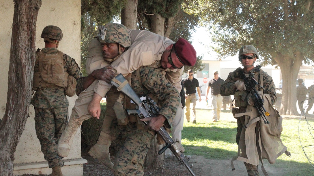 Marines and Sailors with Company K, 3rd Battalion, 7th Marine Regiment, triage and evacuate role-playing victims of a simulated vehicle-borne improvised explosive device during an embassy reinforcement scenario on Joint Forces Training Base Los Alamitos, Feb. 12, 2015. This training was a part of the Special Purpose Marine Air Ground Task Force Crisis Response – Central Command – 15.2 certification exercise, conducted across several locations in the Western United States. The purpose of the CERTEX was to test and certify SPMAGTF CR-CC 15.2 across a broad spectrum of mission essential tasks.