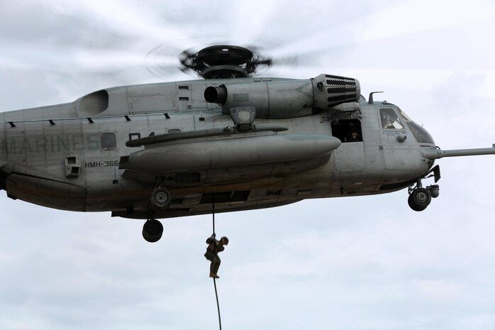 A Marine with Expeditionary Operations Training Group fast-ropes from a CH-53E Super Stallion belonging to Marine Heavy Helicopter Squadron 366 during training at Marine Corps Base Camp Lejeune, N.C., Feb. 4, 2015. Fast-roping is a technique used to quickly exit a helicopter without landing the aircraft. The method allows ground combat troops to enter areas that are typically inaccessible to aircraft.