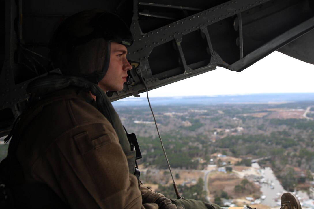 Cpl. Christopher Robichaux observes the horizon from the rear of a CH-53E Super Stallion during training at Marine Corps Base Camp Lejeune, N.C., Feb. 4, 2015. Marine Heavy Helicopter Squadron 366 provided aerial support to the Expeditionary Operations Training Group during the training. HMH-366 conducts training often to maintain proficiency for support of the Marine Air-Ground Task Force. Robichaux is a crewchief with the squadron and a native of New Orleans. 