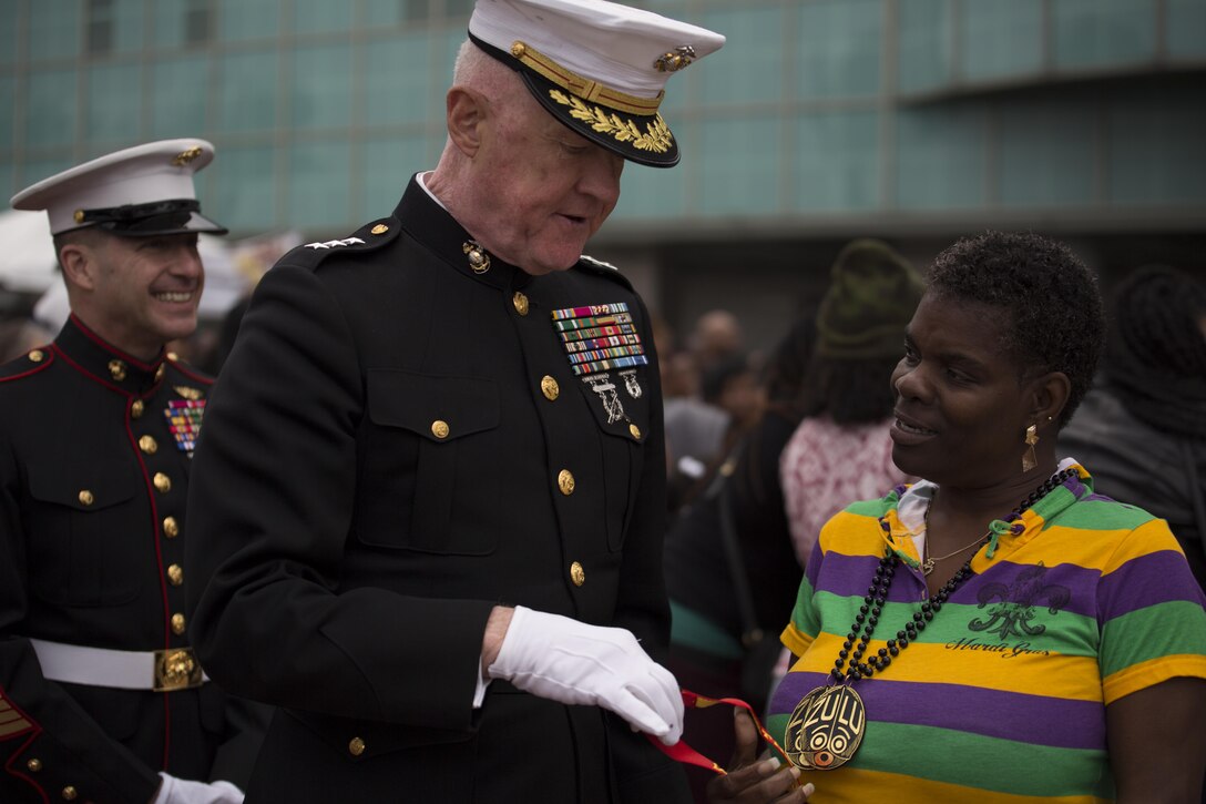 Lt. Gen. Richard P. Mills, commander of Marine Forces Reserve, passes out a Marine Corps lanyard to a citizen celebrating at the Zulu Lundi Gras Festival in downtown New Orleans, Feb. 16, 2015. Mills was joined by Sgt. Maj. Anthony A. Spadaro, sergeant major of MARFORRES, Mr. Gregg T. Habel, executive director of MARFORRES, and his family, to show the military’s continuing support to the city of New Orleans and to celebrate 
Mardi Gras. 
