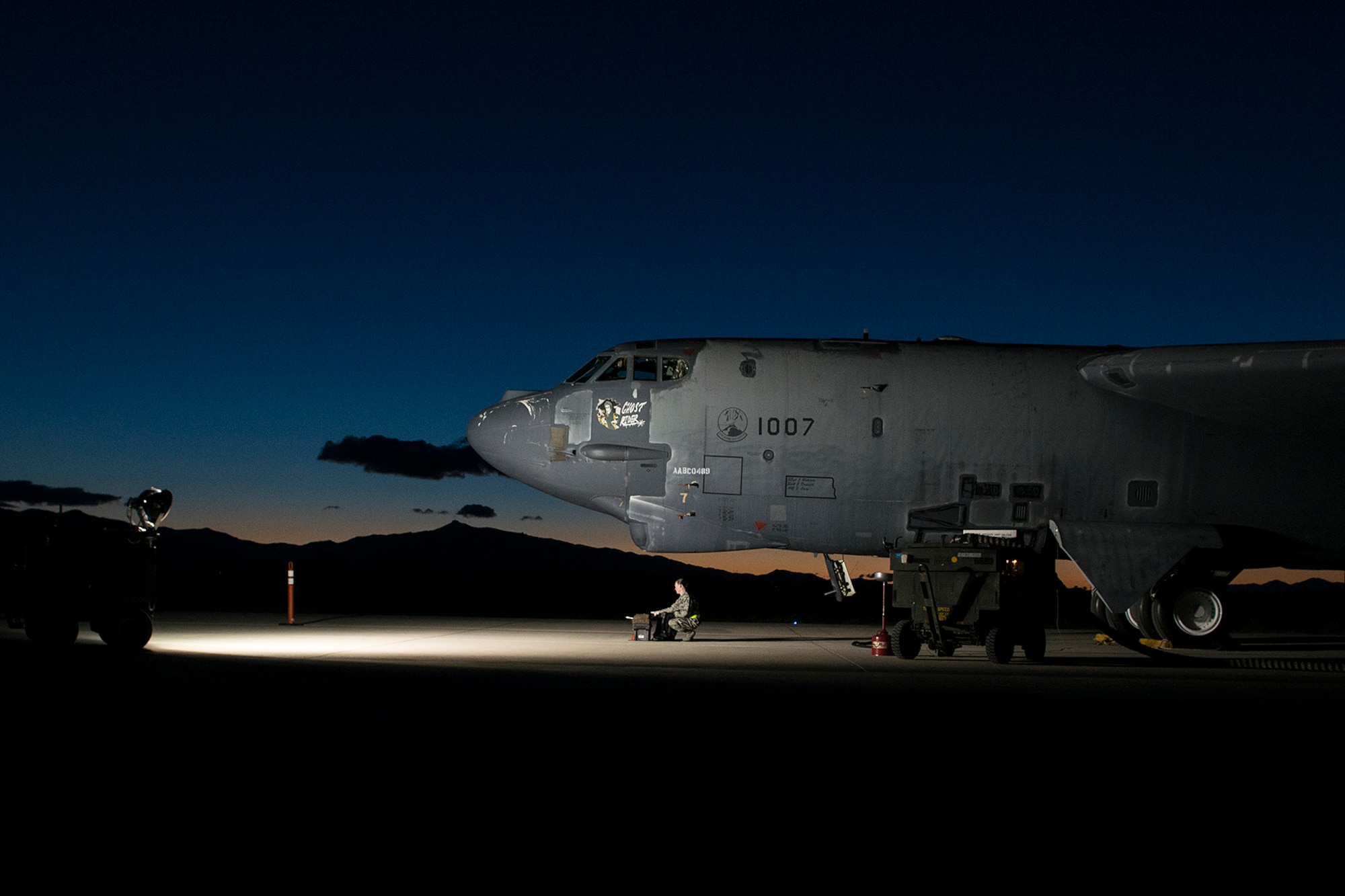 The sun rises behind the "Ghost Rider" as it is prepared for an early morning taxi test on Feb. 12, 2015, Davis-Monthan Air Force Base, Ariz. The B-52H Stratofortress was decommissioned in 2008 and has been sitting in the 309th Aerospace Maintenance and Regeneration Group's "Boneyard", but is being restored to join the active fleet of B-52s. (U.S. Air Force photo by Master Sgt. Greg Steele/Released)