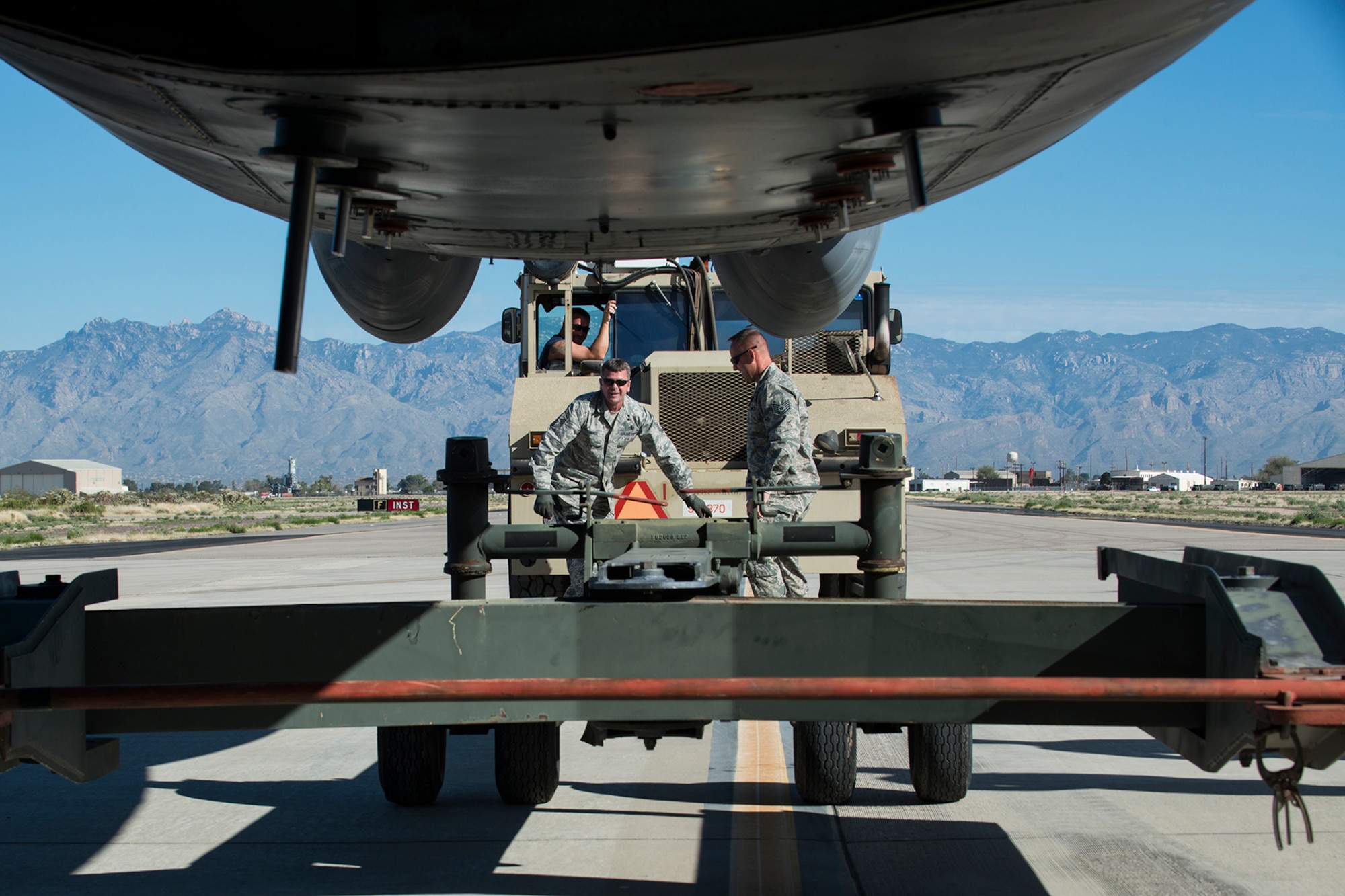 U.S. Air Force Master Sgt. Steve Vance, 307th Aircraft Maintenance Squadron crew chief, and Tech. Sgt. Jonathan Spears, 307th Maintenance Squadron engine specialist, disconnect a tow bar from a B-52H Stratofortress on Feb. 11, 2015, Davis-Monthan Air Force Base, Ariz. The aircraft, tail number 61-007 and known as the "Ghost Rider", is being regenerated for active service after sitting in storage since 2008 when it was decommissioned and sent the Boneyard. (U.S. Air Force photo by Master Sgt. Greg Steele/Released)