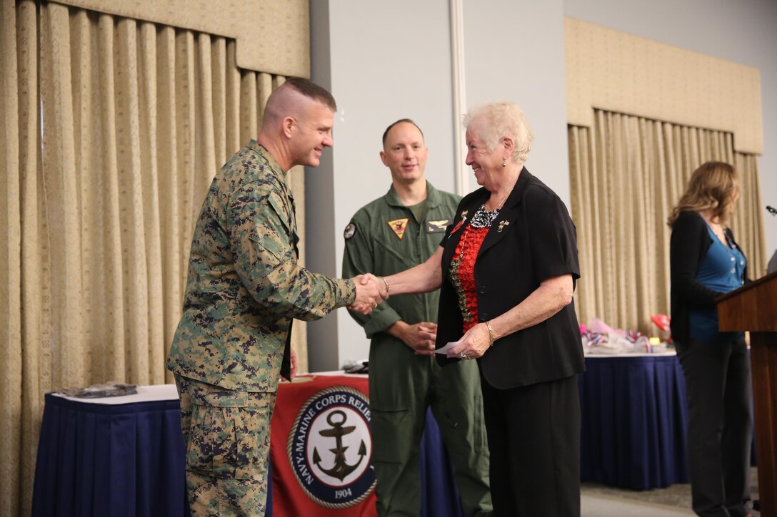 Sgt. Maj. Benjamin Pangborn greets Maria Myers during the Navy-Marine Corps Relief Society Volunteer Appreciation Lunch at Marine Corps Air Station Cherry Point, N.C., Feb. 10, 2015. The ceremony celebrated the accomplishments of more than 60 Marine, Sailor and civilian NMCRS volunteers. Pangborn is the air station sergeant major and Myers is a volunteer with the NMCRS.