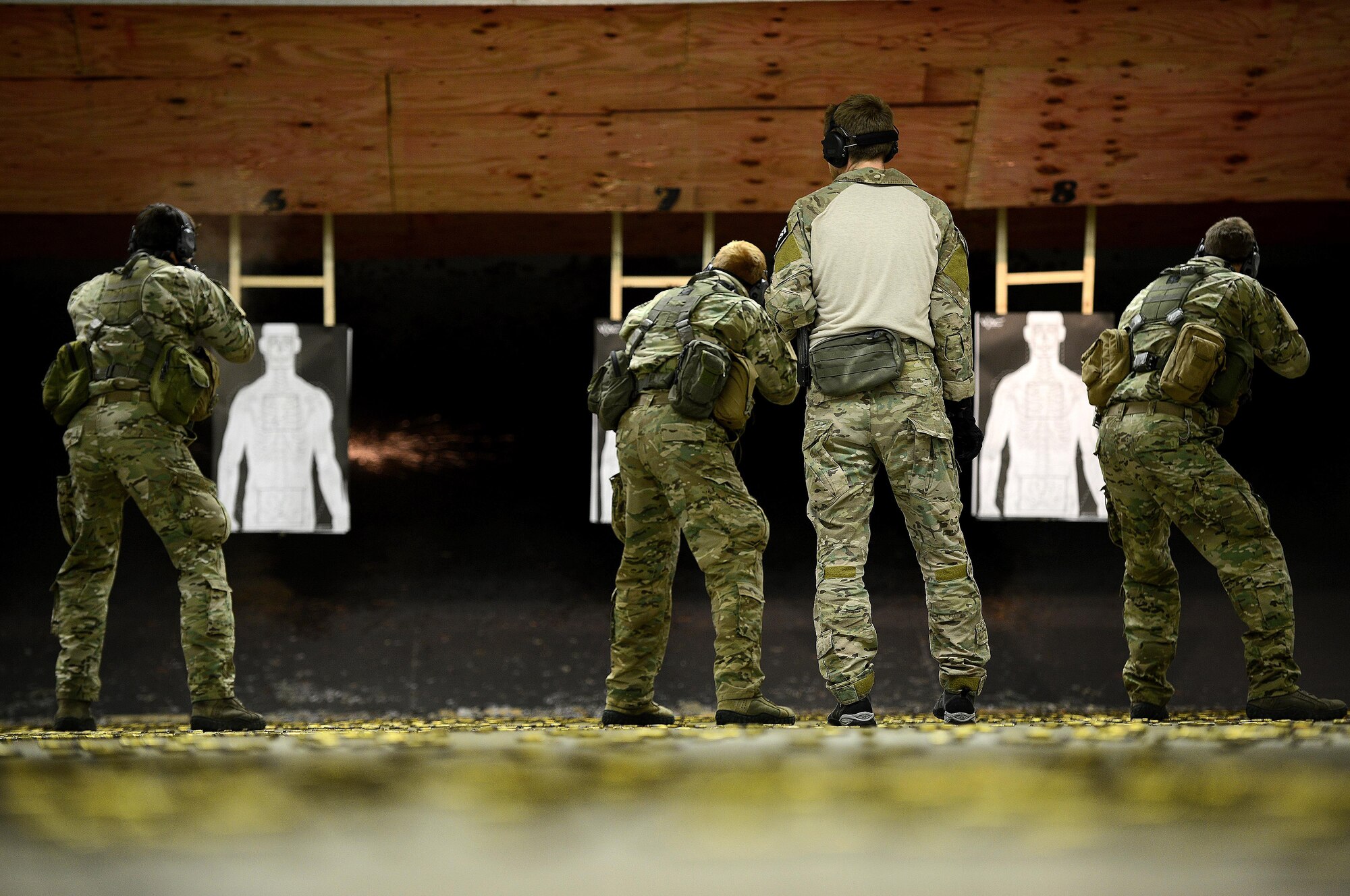 A U.S. Air Force Combat Control trainees assigned to Operating Location C, 342nd Training Squadron, attach their targets to wooden beams before weapons training at Pope Army Air Field, N.C., Feb. 11, 2015. Before earning their berets, CCT and Special Operations Weather Team trainees must complete four months of intense training at Pope in addition to several months of prerequisite training. (U.S. Air Force photo by Airman 1st Class Michael Cossaboom)