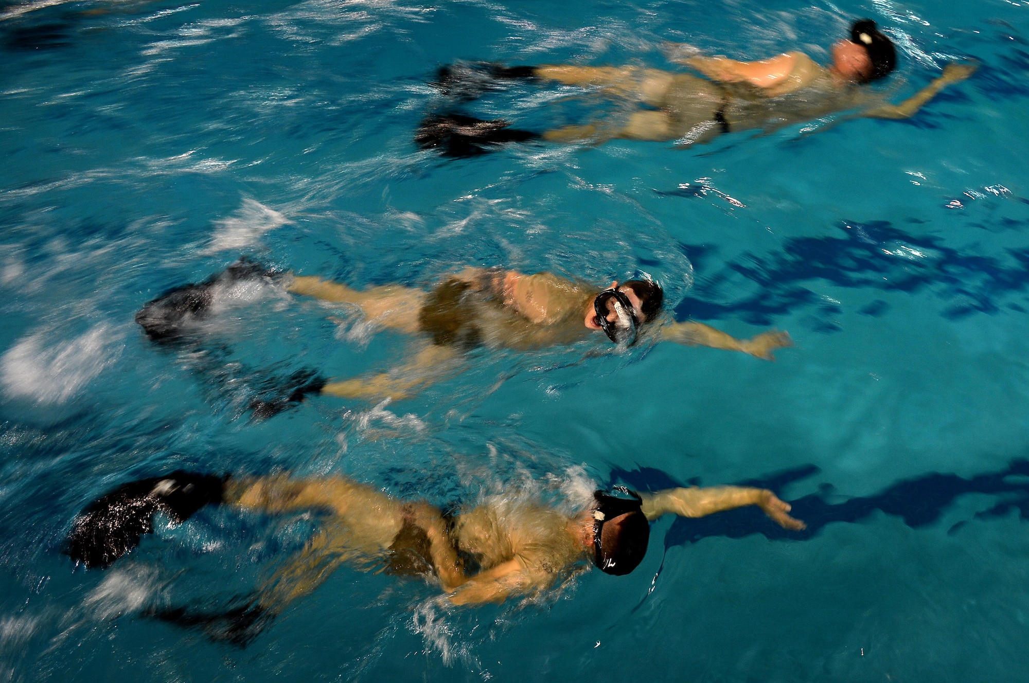 U.S. Air Force Combat Control trainees assigned to Operating Location C, 342nd Training Squadron, swim timed laps during an early morning water circuit training session at Pope Army Airfield, North Carolina, Feb 12, 2015. Airmen training to become CCT or Special Operations Weather Team members have to endure rigorous water exercises in order to become comfortable and efficient in the water. (U.S. Air Force photo by Staff Sgt. Kenny Holston)