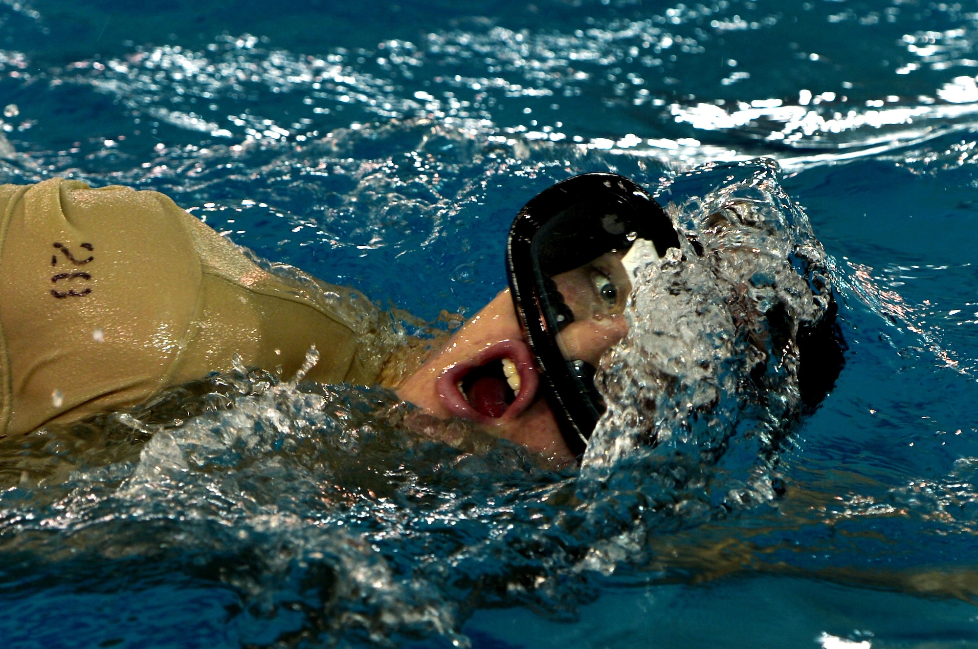 A U.S. Air Force Combat Control trainee assigned to Operating Location C, 342nd Training Squadron, takes a breath while swimming several laps during the warm-up phase of an early morning water circuit training session at Pope Army Airfield, North Carolina, Feb 12, 2015. The students are enduring a 13 week course which will equip them with the final skills needed to be CCT or Special Operations Weather Team qualified. (U.S. Air Force photo by Staff Sgt. Kenny Holston)