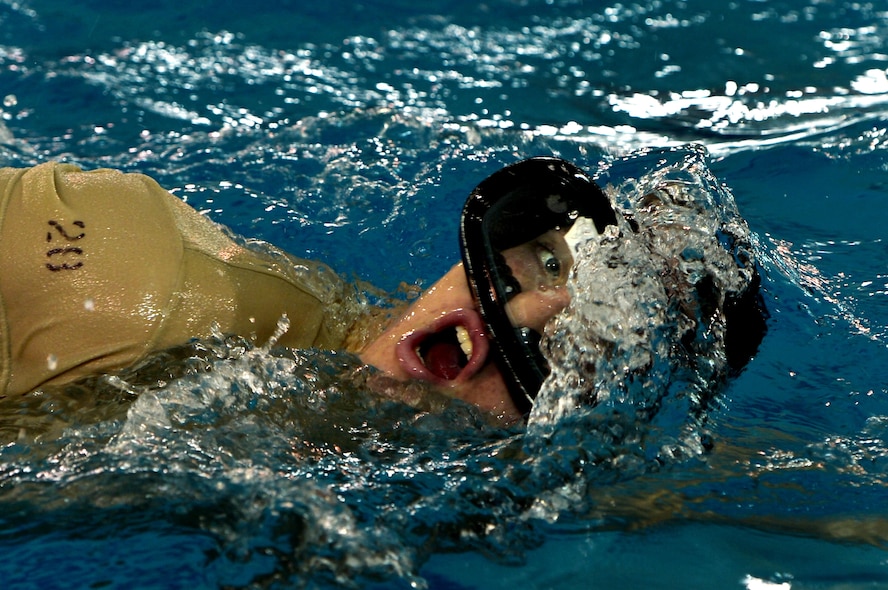 A U.S. Air Force Combat Control trainee assigned to Operating Location C, 342nd Training Squadron, takes a breath while swimming several laps during the warm-up phase of an early morning water circuit training session at Pope Army Airfield, North Carolina, Feb 12, 2015. The students are enduring a 13 week course which will equip them with the final skills needed to be CCT or Special Operations Weather Team qualified. (U.S. Air Force photo by Staff Sgt. Kenny Holston)