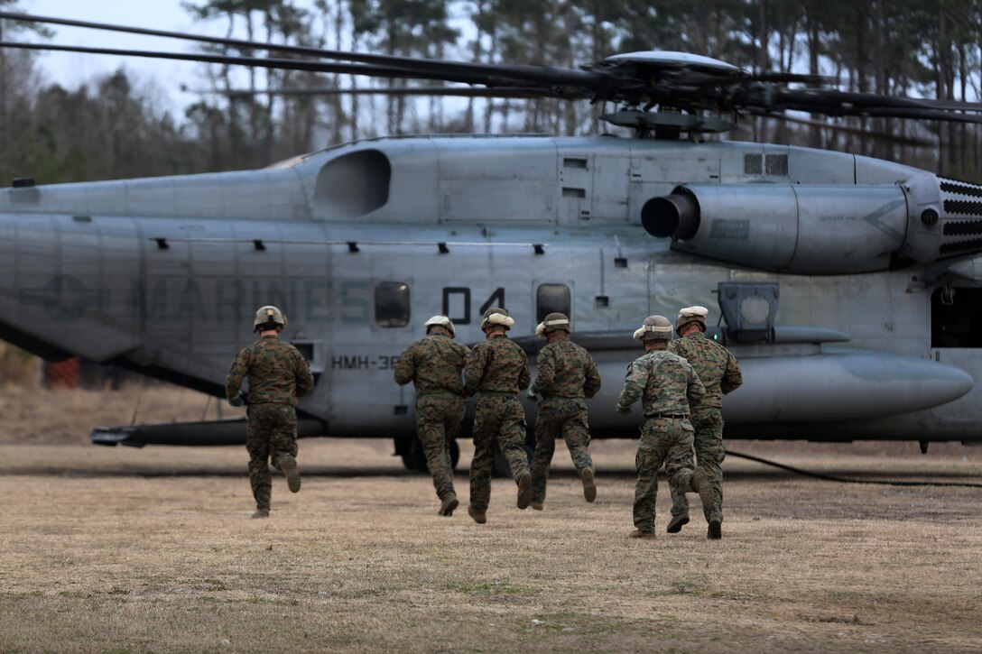 Marines with the Expeditionary Operations Training Group prepare to board a CH-53E Super Stallion belonging to Marine Heavy Helicopter Squadron 366 during fast-rope training at Marine Corps Base Camp Lejeune, N.C., Feb. 4, 2015. Fast-roping is a technique used to quickly exit a helicopter without landing the aircraft. The method allows ground combat troops to enter areas that are typically inaccessible to aircraft.