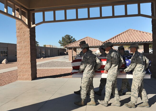 Members of the Nellis Air Force Base Honor Guard practice properly carrying a casket at Nellis AFB, Nev. Feb. 17, 2015. Today, the American flag that covers the casket symbolizes the deceased service in the armed forces of the United States of America. (U.S. Air Force photo by Airman 1st Class Rachel Loftis)