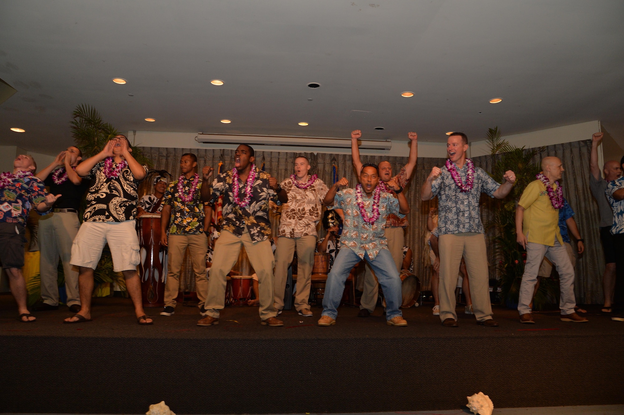 Members of the 15th Wing perform a warrior call during the entertainment portion of  the 15th Wing 2014 Annual Awards Luau at the Historic Hickam Officers' Club on Joint Base Pearl Harbor-Hickam, Hawaii, Feb. 13, 2015.The performance continued with everyone on stage attempting to perform a traditional Warrior dance. (U.S. Air Force photo by Tech. Sgt. Aaron Oelrich/Released)