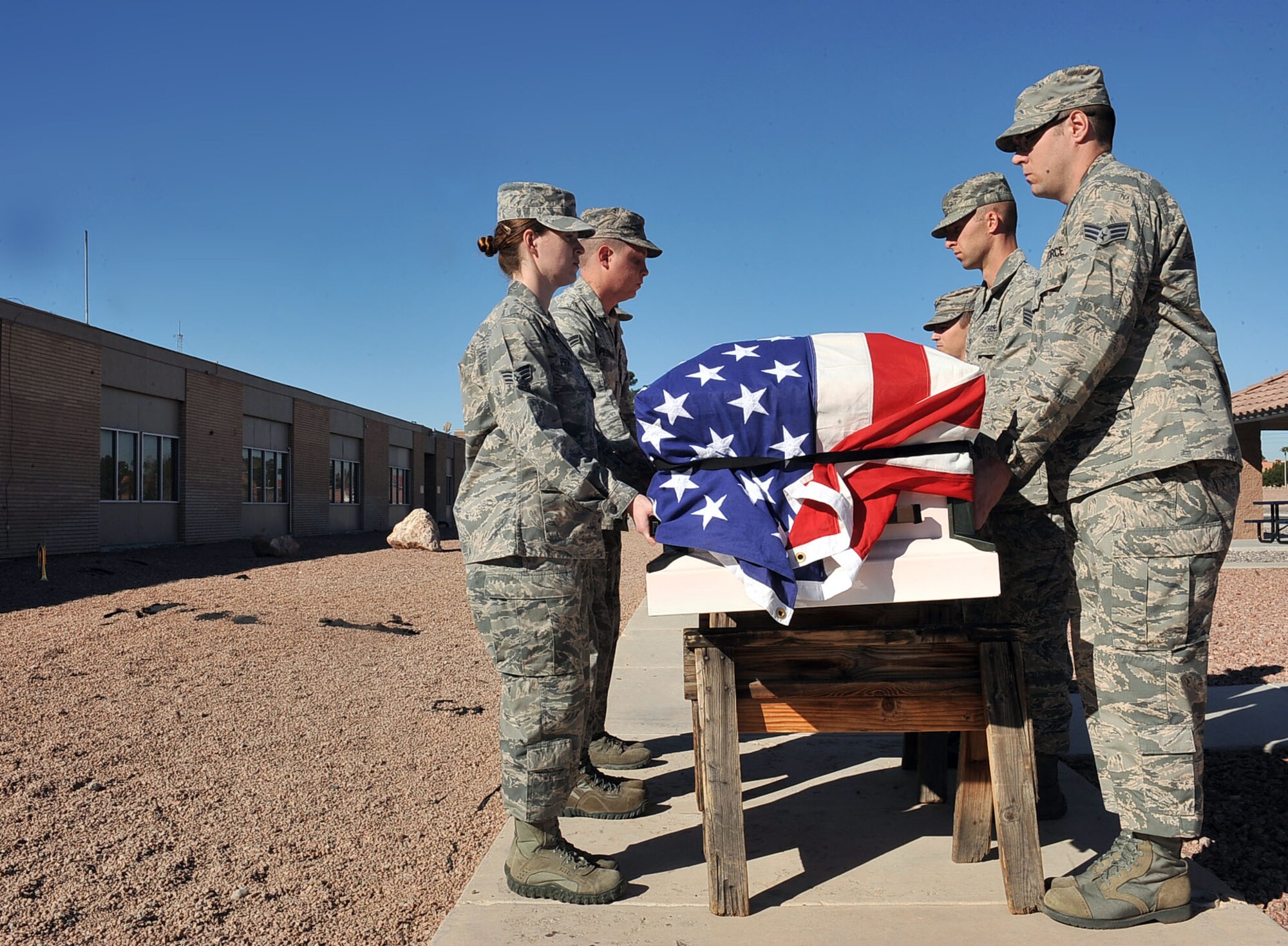 Members of the Nellis Air Force Base Honor Guard practices properly carrying a casket at Nellis AFB, Nev. Feb. 17, 2015. The honor guard represents the Air Force in ceremonial functions in southern Nevada, Arizona, Utah and some areas of California. (U.S. Air Force photo by Airman 1st Class Rachel Loftis)