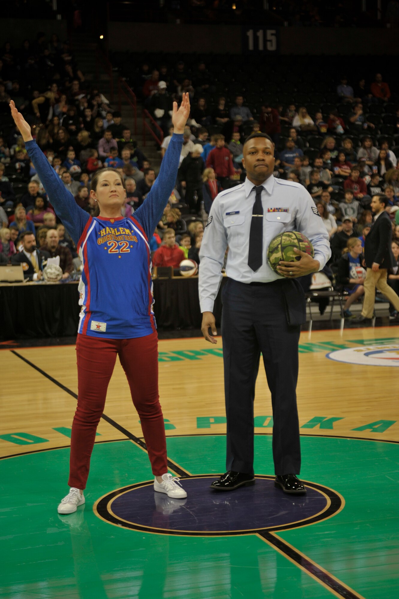 Stacy, the Harlem Globetrotters emcee, announces Senior Airman Christopher Atkins, a 92nd Medical Group aerospace medical technician, as the Hometown Hero during the game Feb. 17, 2015, at the Spokane Arena in Spokane, Wash. Atkins was recognized as the Hometown Hero for helping create two medical group morale programs. He also acts as a supervisor and fills the role of an NCO in his clinic. (U.S. Air Force photo/Airman 1st Class Taylor Bourgeous)