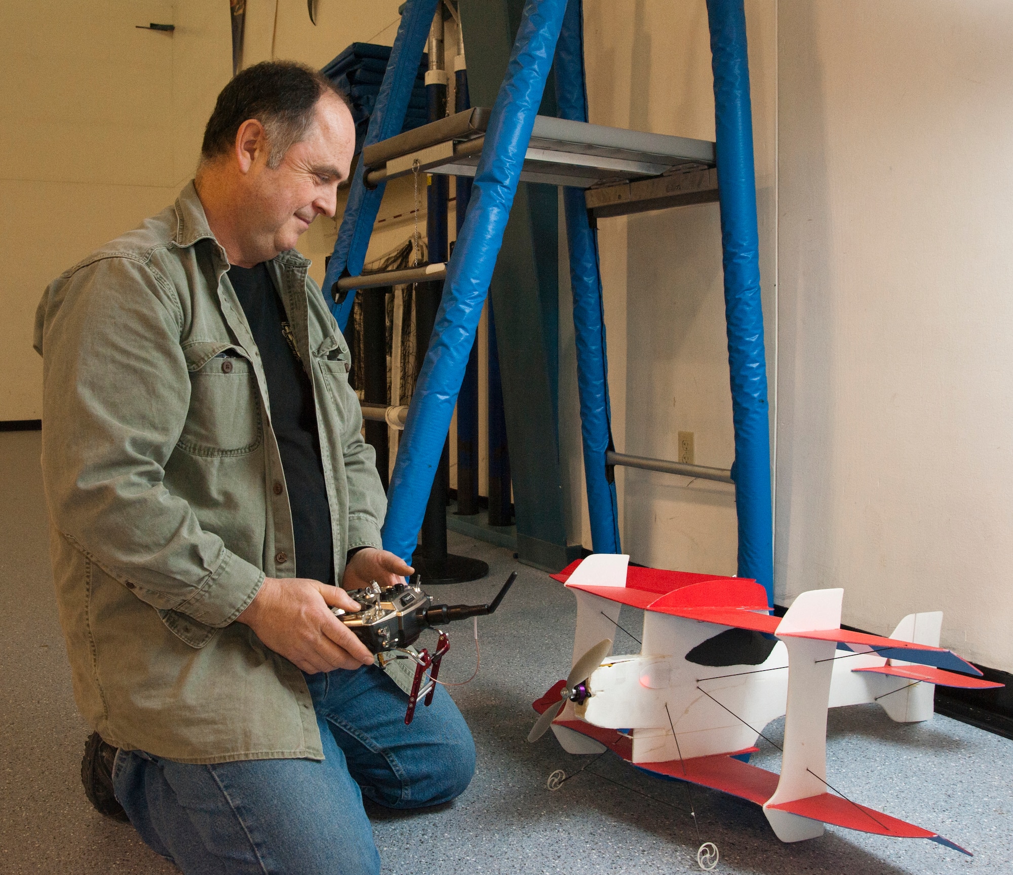Edward Cunningham, Alaska Radio Control Society member and remote piloted aircraft pilot, prepares his battery-powered aircraft to fly at the Lumen Christi High School gymnasium, Feb. 15, 2015. It takes about 15 to 20 minutes for the RPA battery to fully charge before flying. Cunningham is native to Anchorage, Alaska. (U.S. Air Force photo/Airman 1st Class Tammie Ramsouer)