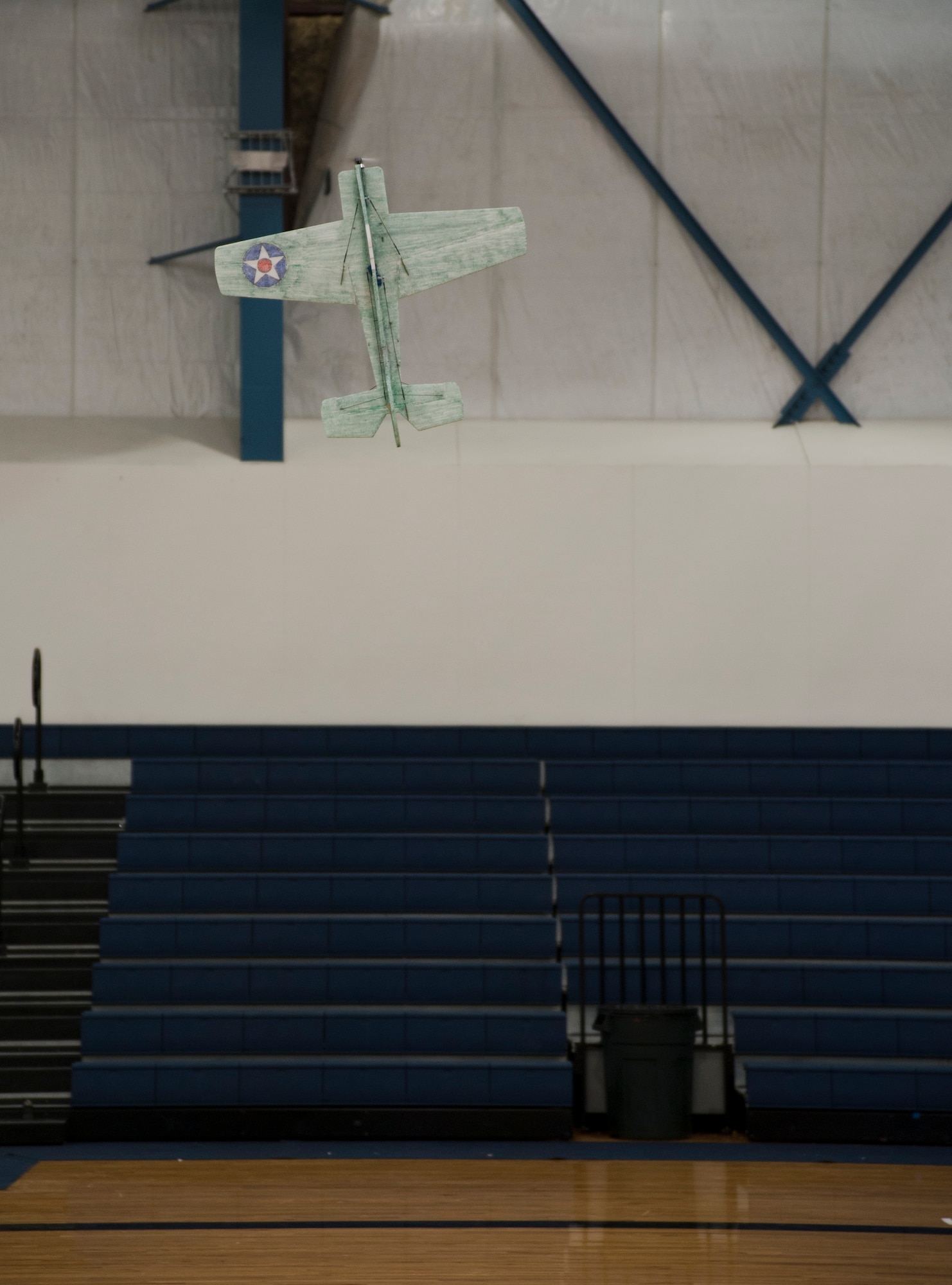A P-40 Warhawk remotely piloted aircraft flies inside Lumen Christi High School gymnasium, Feb. 15, 2015. Many RPAs are decorated to look like actual planes that are or have been in use for flying purposes, whether for wartime or peacetime. This gymnasium is one of the many approved flying sites the Alaska Radio Control Society can fly through the societies membership in the Academy of Modeling Aeronautics. (U.S. Air Force photo/Airman 1st Class Tammie Ramsouer)