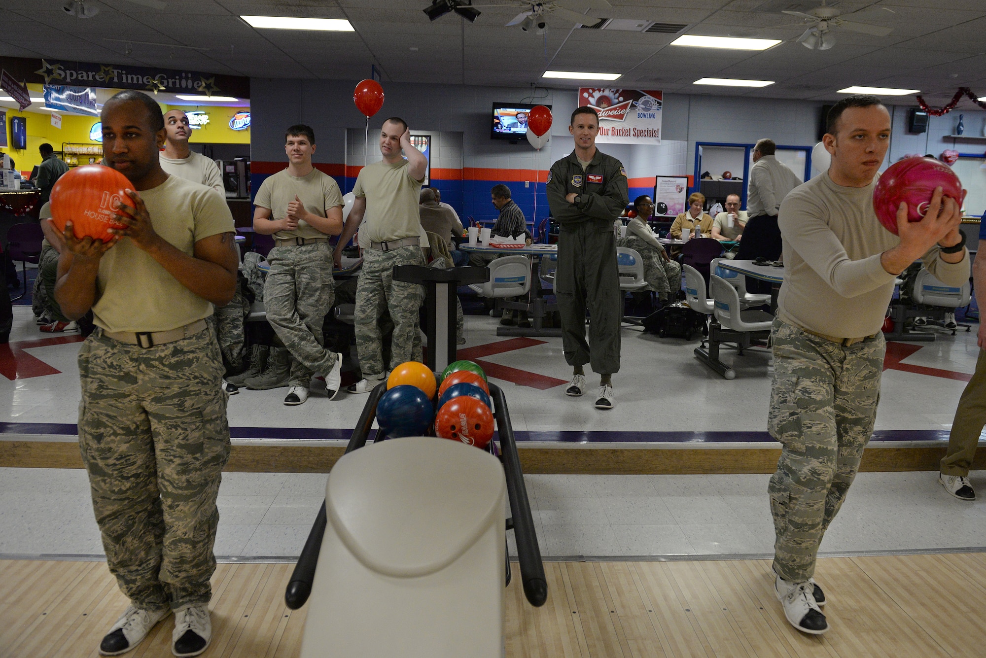 Staff Sgt Carlos Marles, 375th Aeromedical Evacuation Squadron technician (right), prepares his approach while another bowler waits during the first Sexual Assault Prevention and Response Bowl-a-thon, Scott Air Force Base, Ill., Feb. 12, 2015. The theme of the event was ‘Healthy Relationships Matter’. (U.S. Air Force photo by Airman 1st Class Erica Crossen)