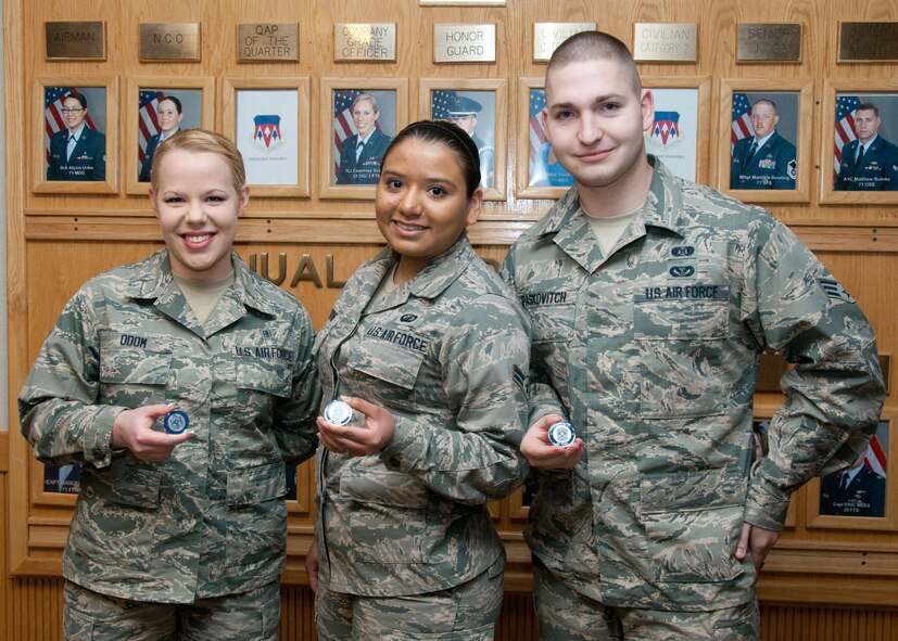 VANCE AIR FORCE BASE, Okla. -- (From left) Senior Airman Zachary Paskovitch, Retired Chief Master Sgt. of the Air Force Frederick Finch and Airmen 1st Class Faith Odom and Nancy Osborne share a moment following a coining session at 71st Flying Training Wing headquarters Feb. 11. (U.S. Air Force photo / Terry Wasson)