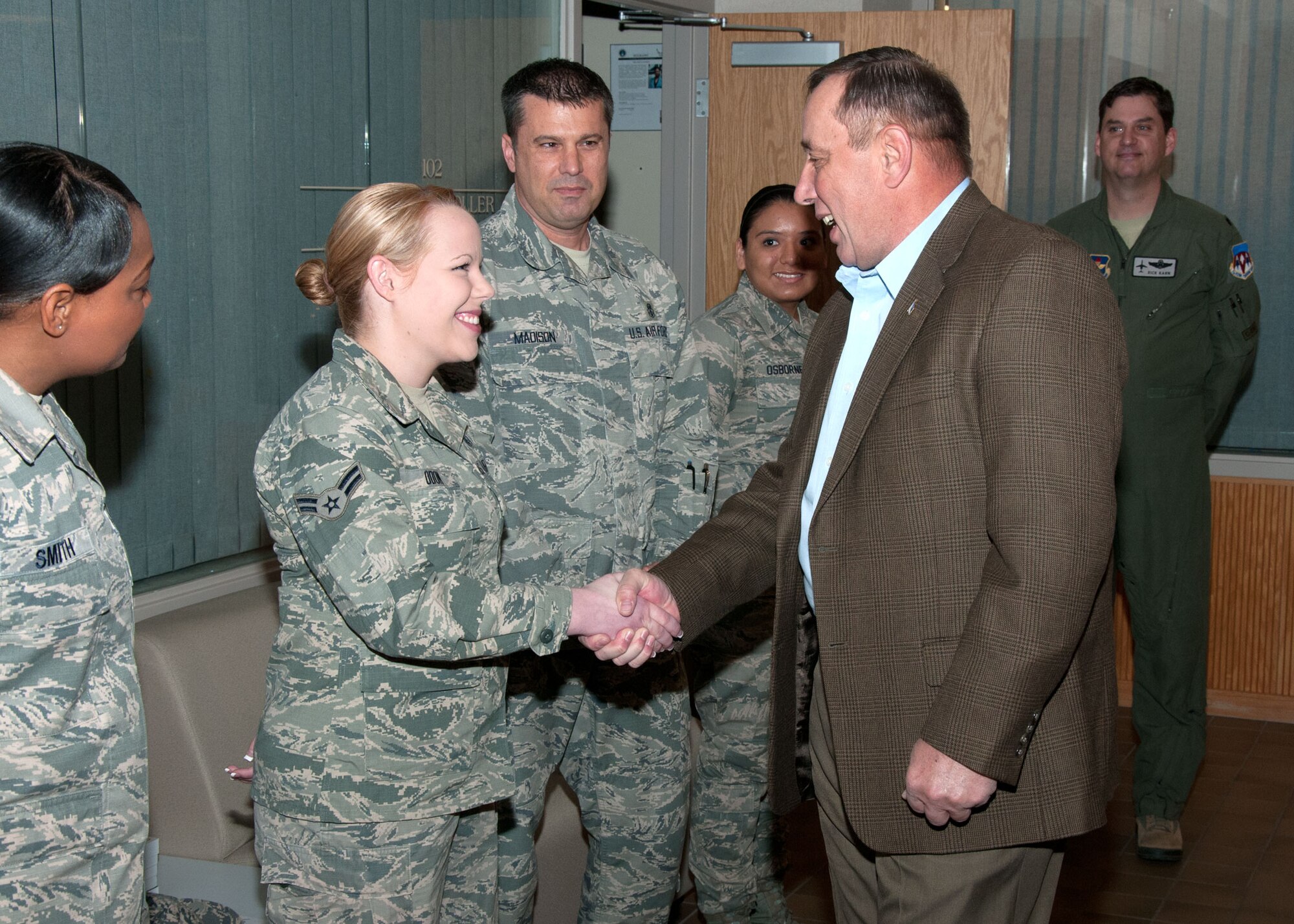VANCE AIR FORCE BASE, Okla. -- (From left) Airmen 1st Class Faith Odom and Nancy Osborne Senior Airman Zachary Paskovitch show their Chief Master Sergeant of the Air Force coins at the 71st Flying Training Wing headquarters Feb. 11. Retired Chief Master Sgt. of the Air Force Frederick Finch, the Air Force's 13th senior enlisted leader, visited and held calls with all ranks, Feb. 11. (U.S. Air Force photo / Terry Wasson)