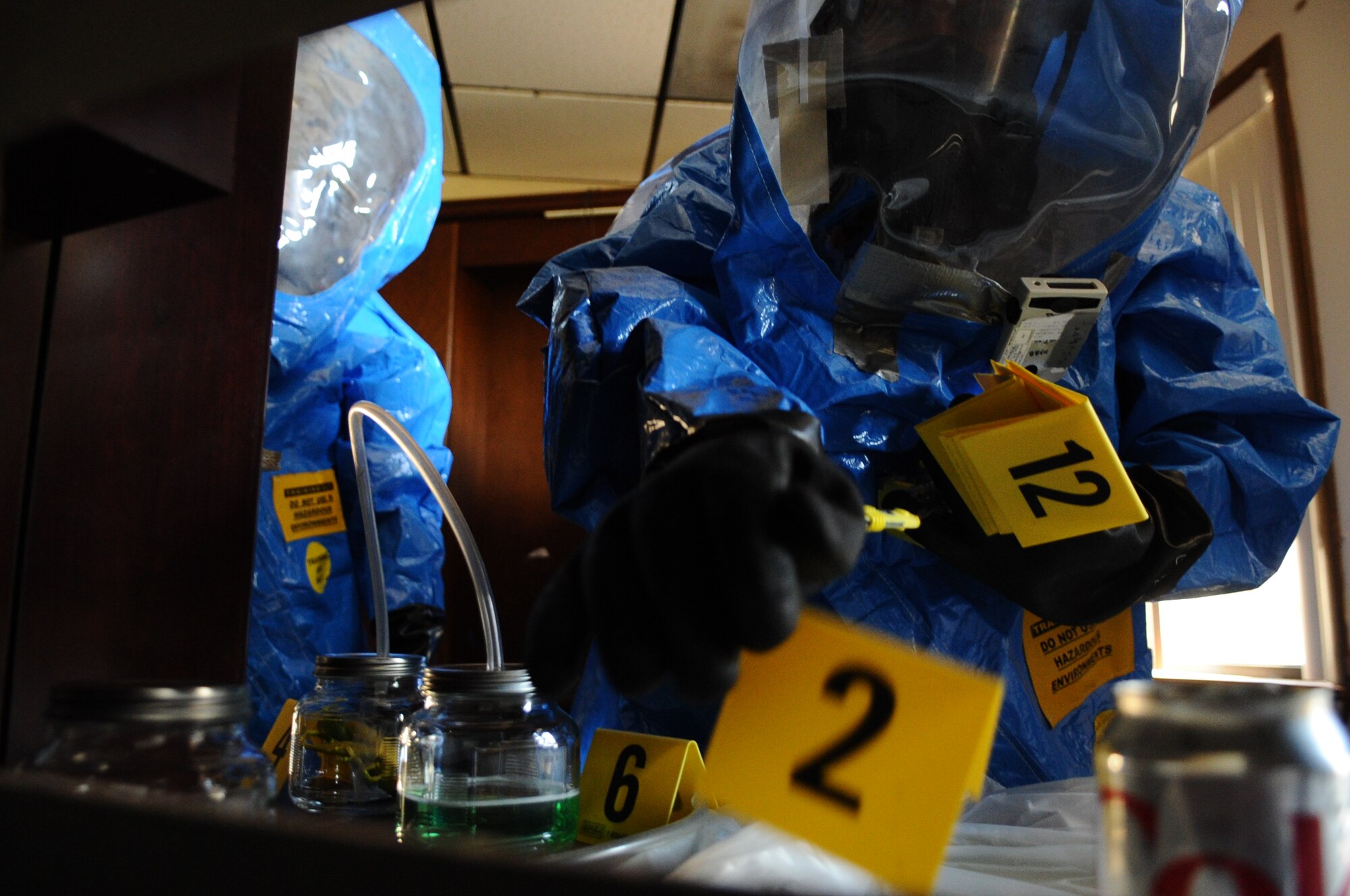 Airmen collect samples of hazardous materials during the Integrated Base Emergency Response Capabilities Training exercise Feb. 10 on Tyndall. The information gathered from the Airmen would be used to determine the area's level of contamination. (U.S. Air Force photo by Airman 1st Class Ty-Rico Lea)