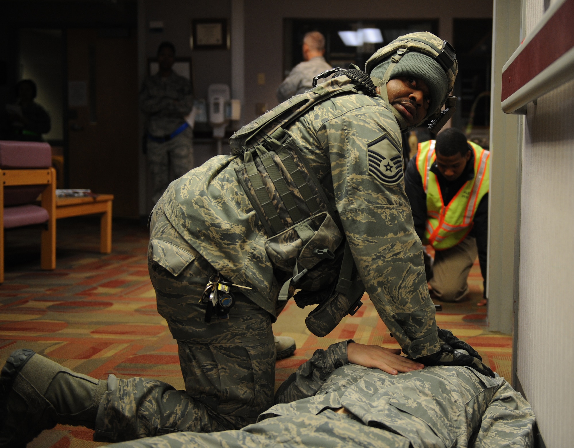 U.S. Air Force Master Sgt. David Shaw, 509th Security Forces Squadron fire team leader, provides care to a moulaged victim during an active-shooter exercise at Whiteman Air Force Base, Mo., Feb. 11, 2015. Personnel participating in the exercise treated the victims based off of simulated wounds. (U.S. Air Force photo by Airman 1st Class Joel Pfiester/Released)
