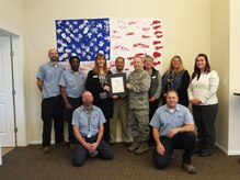 Colonel Jeffrey DeVore, Joint Base Charleston commander, presents Forrest City Military Communities of JB Charleston with the 2014 Multifamily Real Estate Award for Customer Service Excellence Feb. 11, 2015 at JB Charleston, S.C. Forrest City was recognized for their customer service for all four Air Base neighborhoods. (Courtesy photo)