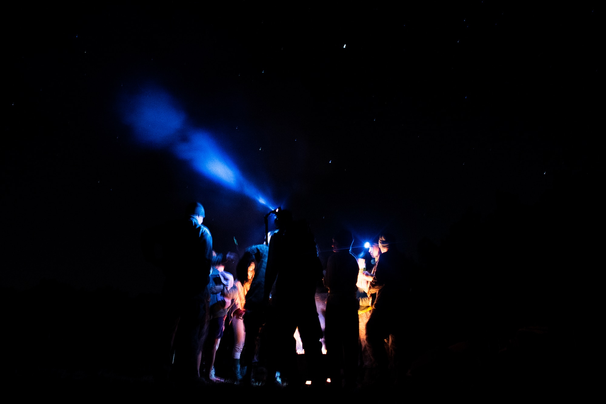 Airmen from the 1st Combat Camera Squadron hangout around a campfire during an Ability to Survive and Operate Exercise Feb.  12, 2015 at North Auxiliary Airfield, S.C. The ATSO exercise is an annual event designed to test the ability of Air Force combat camera Airmen to survive, operate and provide imagery in an austere environment. Combat camera Airmen document a full range of military operations in support of senior leaders and combatant commanders. (U.S. Air Force photo/Senior Airman Jared Trimarchi)
