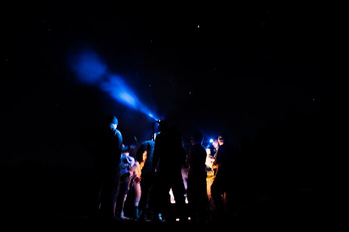 Airmen from the 1st Combat Camera Squadron hangout around a campfire during an Ability to Survive and Operate Exercise Feb.  12, 2015 at North Auxiliary Airfield, S.C. The ATSO exercise is an annual event designed to test the ability of Air Force combat camera Airmen to survive, operate and provide imagery in an austere environment. Combat camera Airmen document a full range of military operations in support of senior leaders and combatant commanders. (U.S. Air Force photo/Senior Airman Jared Trimarchi)