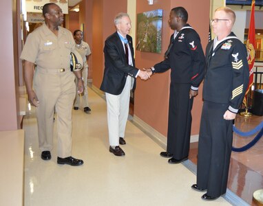 Petty Officer 3rd Class Charles Simmons, a general duty corpsman and Petty Officer 1st Class John Furr, a hospital corpsman at Naval Health Clinic Charleston, S.C., greet Congressional Medal of Honor recipient, Maj. Gen. (Ret.) James Livingston, at the NHCC, Joint Base Charleston, Feb. 13, 2015. During his visit to NHCC, Livingston toured the facility and met with various Sailors. Livingston was accompanied on his tour by Capt. Marvin Jones, NHCC commanding officer (left); and Senior Chief Floreen Johnson, NHCC’s acting command master chief (center). (U.S. Navy photo / Kris Patterson)