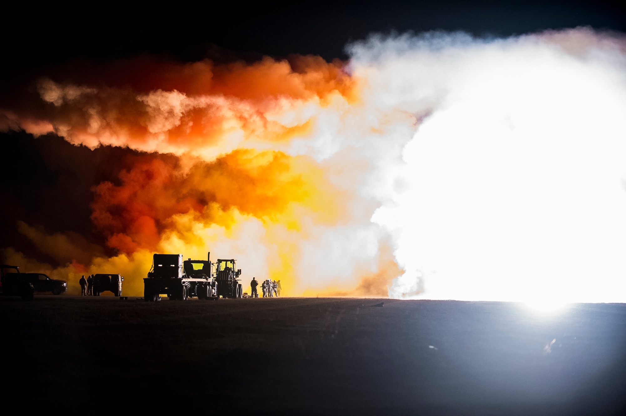 Explosive ordnance Airmen from the 628th Civil Engineer Squadron set off ground burst simulators Feb. 11, 2015 at North Auxiliary Airfield, S.C, during an Ability to Survive and Operate Exercise. The ATSO exercise is an annual event designed to test the ability of Air Force combat camera Airmen to survive, operate and provide imagery in an austere environment. Combat camera Airmen document a full range of military operations in support of senior leaders and combatant commanders. (U.S. Air Force photo/Senior Airman Jared Trimarchi)