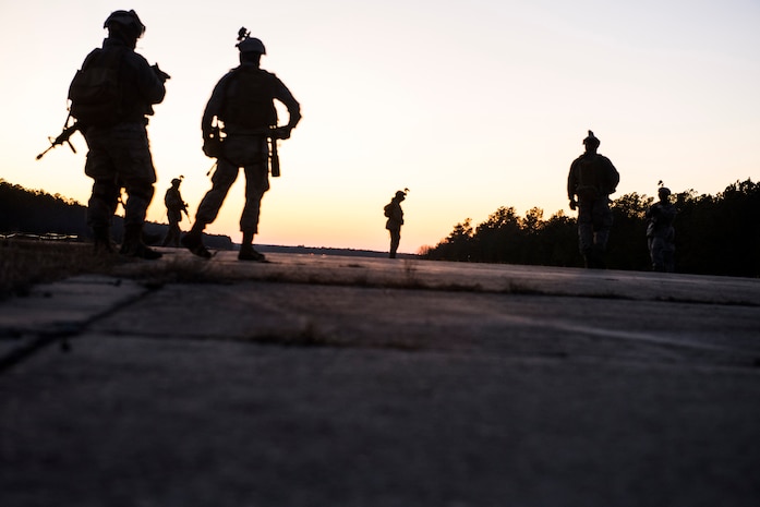 Airmen from the 1st Combat Camera Squadron and begin a night patrol during an Ability to Survive and Operate Exercise Feb. 11, 2015 at North Auxiliary Airfield, S.C. The ATSO exercise is an annual event designed to test the ability of Air Force combat camera Airmen to survive, operate and provide imagery in an austere environment. Combat camera Airmen document a full range of military operations in support of senior leaders and combatant commanders. (U.S. Air Force photo/Senior Airman Jared Trimarchi)