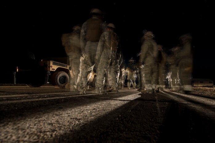 Airmen from the 1st Combat Camera Squadron prepare for a night patrol during an Ability to Survive and Operate Exercise Feb. 11, 2015 at North Auxiliary Airfield, S.C. The ATSO exercise is an annual event designed to test the ability of Air Force combat camera Airmen to survive, operate and provide imagery in an austere environment. Combat camera Airmen document a full range of military operations in support of senior leaders and combatant commanders. (U.S. Air Force photo/Senior Airman Jared Trimarchi)