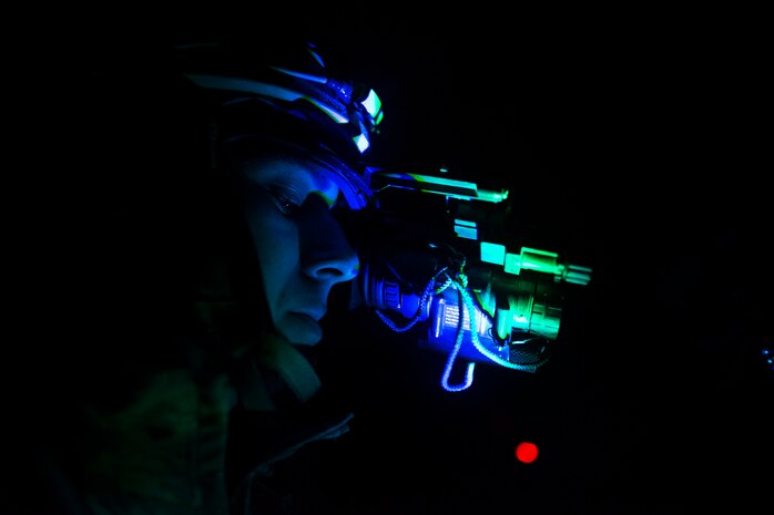 Senior Airman Jordan Castelan, a photojournalist assigned to the 1st Combat Camera Squadron, assess his night vision goggles Feb. 9, 2015, at North Auxiliary Airfield, S.C., during an Ability to Survive and Operate exercise. The ATSO exercise is an annual event designed to test the ability of Air Force combat camera Airmen to survive, operate and provide imagery in an austere environment. Combat camera Airmen document a full range of military operations in support of senior leaders and combatant commanders. (U.S. Air Force photo/Senior Airman Jared Trimarchi)