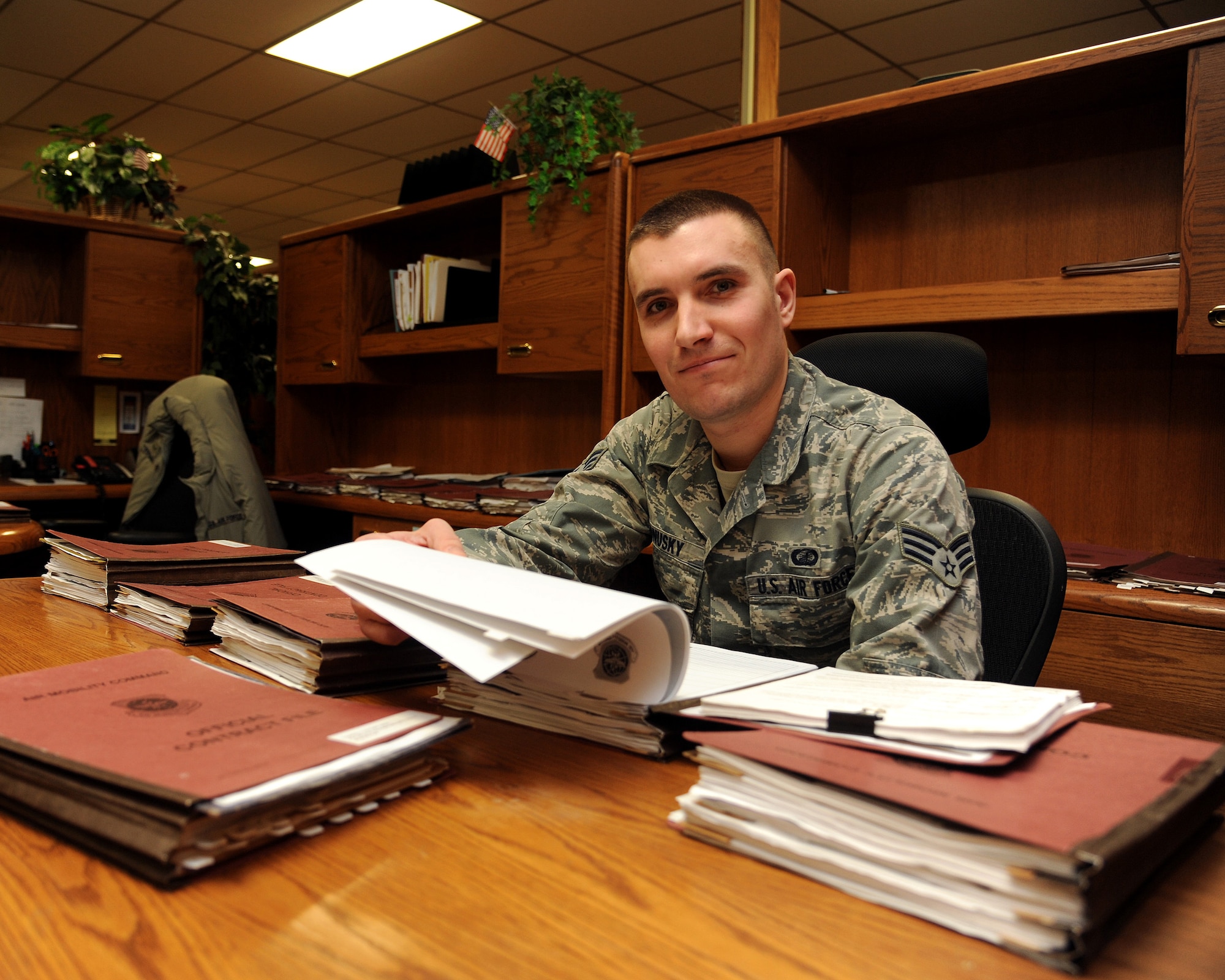 Senior Airman Alex Ponusky 319th Contracting Flight contract specialist sorts through a few of the base’s open contracts dealing with projects under $750,000 Feb. 18, 2015 on Grand Forks Air Force Base, N.D. In 2014, Ponusky awarded and administered 20 projects valued at roughly $4.5Mil., with the vast majority of these projects being completed by local companies' in Grand Forks. Ponusky is this week’s warrior of the week for the third week of February. (U.S. Air Force photo/Senior Airman Zachiah Roberson) 