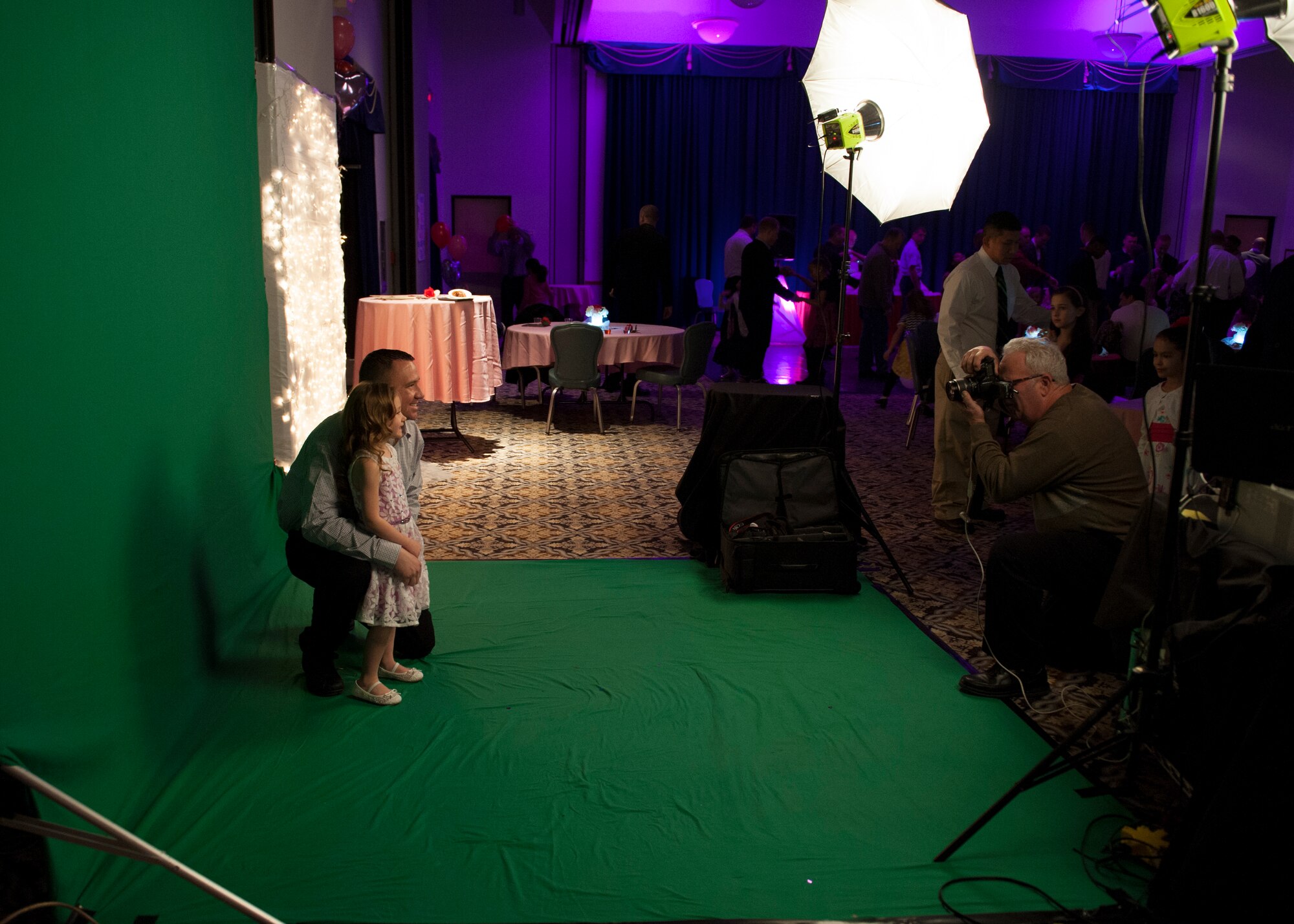 Staff Sgt. David Maddock, 436th Operations Support Squadron air traffic controller, and his daughter Kali, 4, pose for a photo in front of a green screen, during a Daddy Daughter Dance Feb. 13, 2015, at the Landings Club on Dover Air Force Base, Del. Many families took the opportunity to have professional portraits taken. (U.S. Air Force photo/Airman 1st Class Zachary Cacicia)