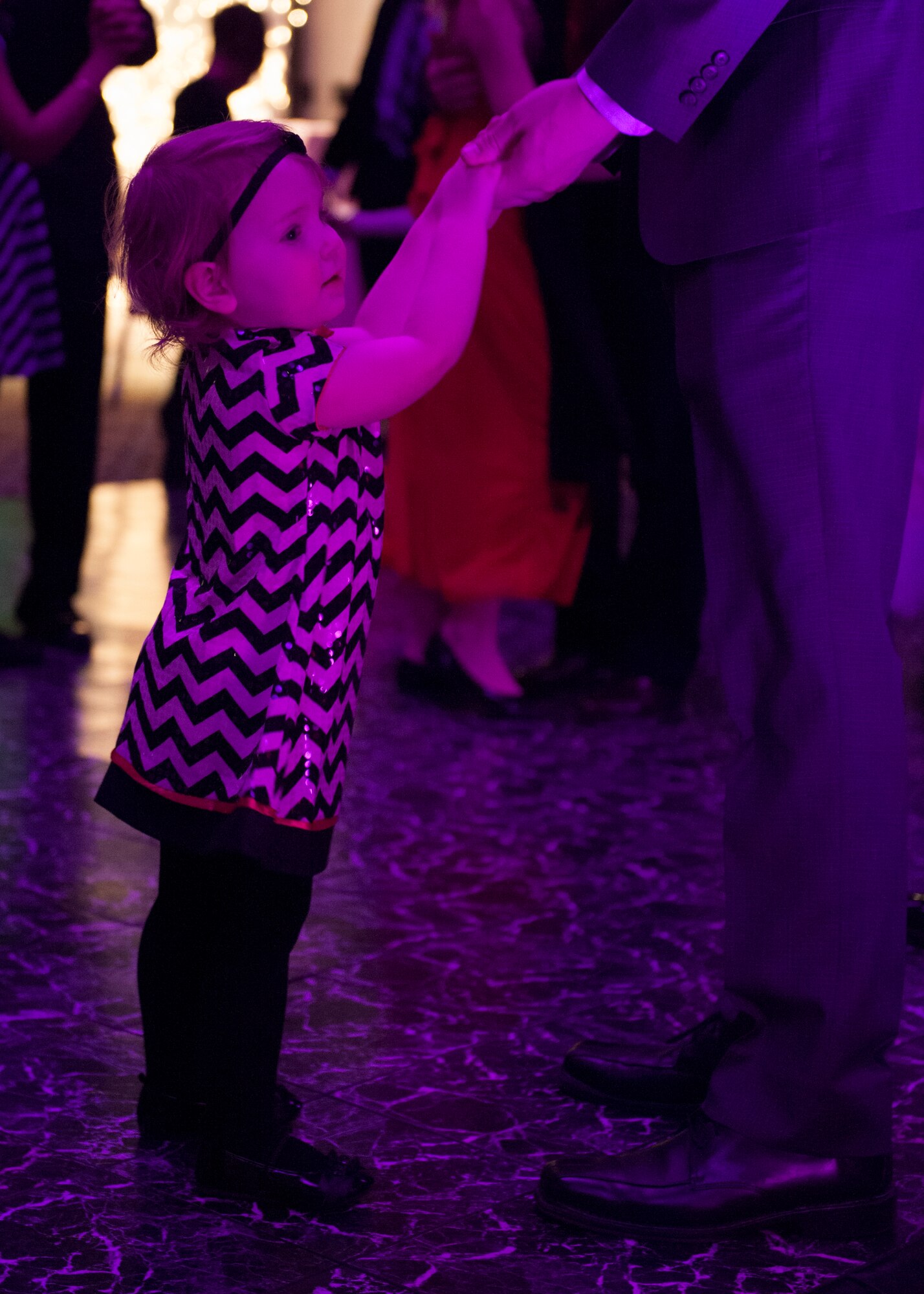 Capt. Jared Tenpas, 9th Airlift Squadron pilot, dances with his daughter Riley, 3, during a Daddy Daughter Dance Feb. 13, 2015, at the Landings Club on Dover Air Force Base, Del. The event was open to all Team Dover fathers and daughters. (U.S. Air Force photo/Airman 1st Class Zachary Cacicia)