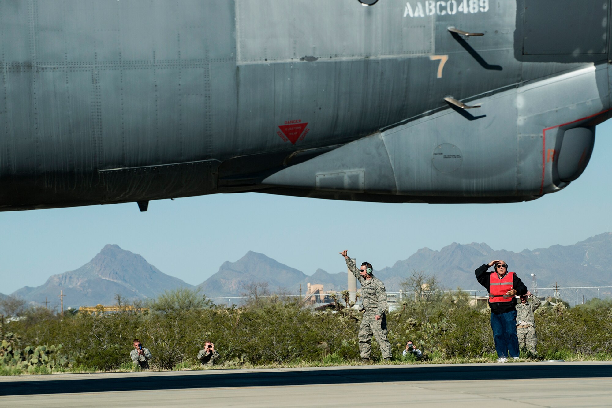 Jerry Fugere salutes the “Ghost Rider” as it taxis by on Feb. 13, 2015, Davis-Monthan Air Force Base, Ariz. In 1962, Fugere was the first crew chief of the B-52H Stratofortress, tail number 61-007, and is given the honor of marshaling the jet from its parking spot before taking its first flight since being decommissioned in 2008. (U.S. Air Force photo by Master Sgt. Greg Steele/Released)