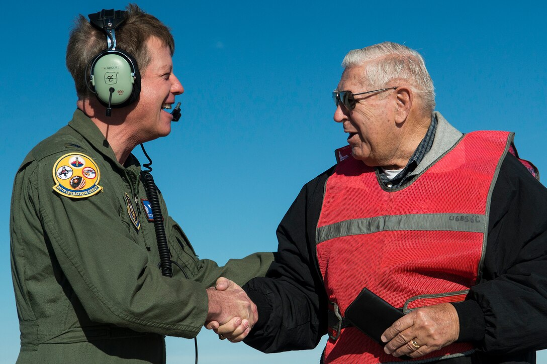 U.S. Air Force Col. Keith Schultz, 307th Operations Group commander, greets Jerry Fugere before taking flight in the "Ghost Rider" on Feb. 13, 2015, Davis-Monthan Air Force Base, Ariz. In 1962, Fugere was the first crew chief of a B-52H Stratofortress, tail number 61-007, and is given the honor of marshaling the jet from its parking spot before taking its first flight since being decommissioned in 2008. (U.S. Air Force photo by Master Sgt. Greg Steele/Released)
